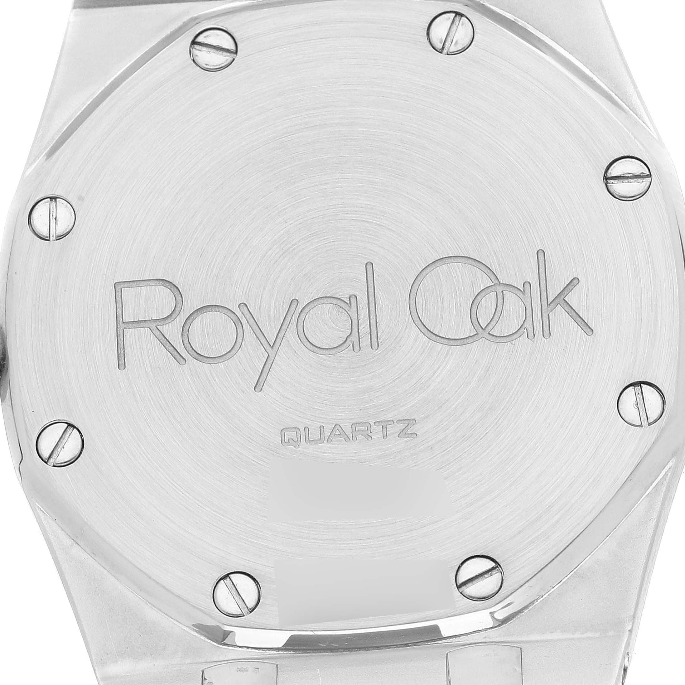 The image shows the back plate of an Audemars Piguet Royal Oak 56303SA Men's Steel and Gold (two tone) Champagne Dial 56303SA Men's Steel and Gold (two tone) Champagne Dial watch, featuring engraved text and visible screws.