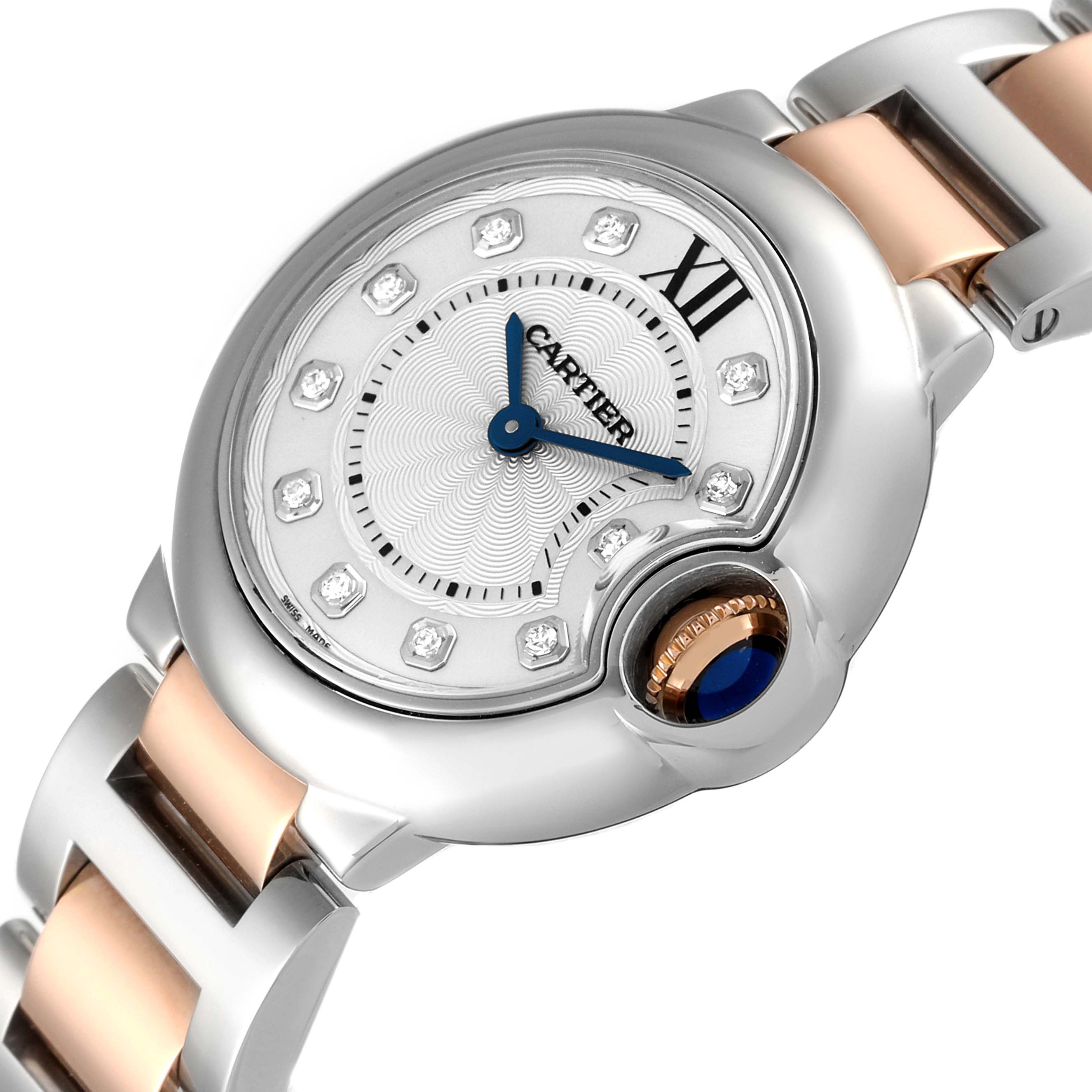 The image shows a close-up angle of the Cartier Ballon Bleu WE902030 Women
s Steel and Gold (two tone) Silver Dial WE902030 Women
s Steel and Gold (two tone) Silver Dial watch, highlighting its face, crown, and part of the bracelet.