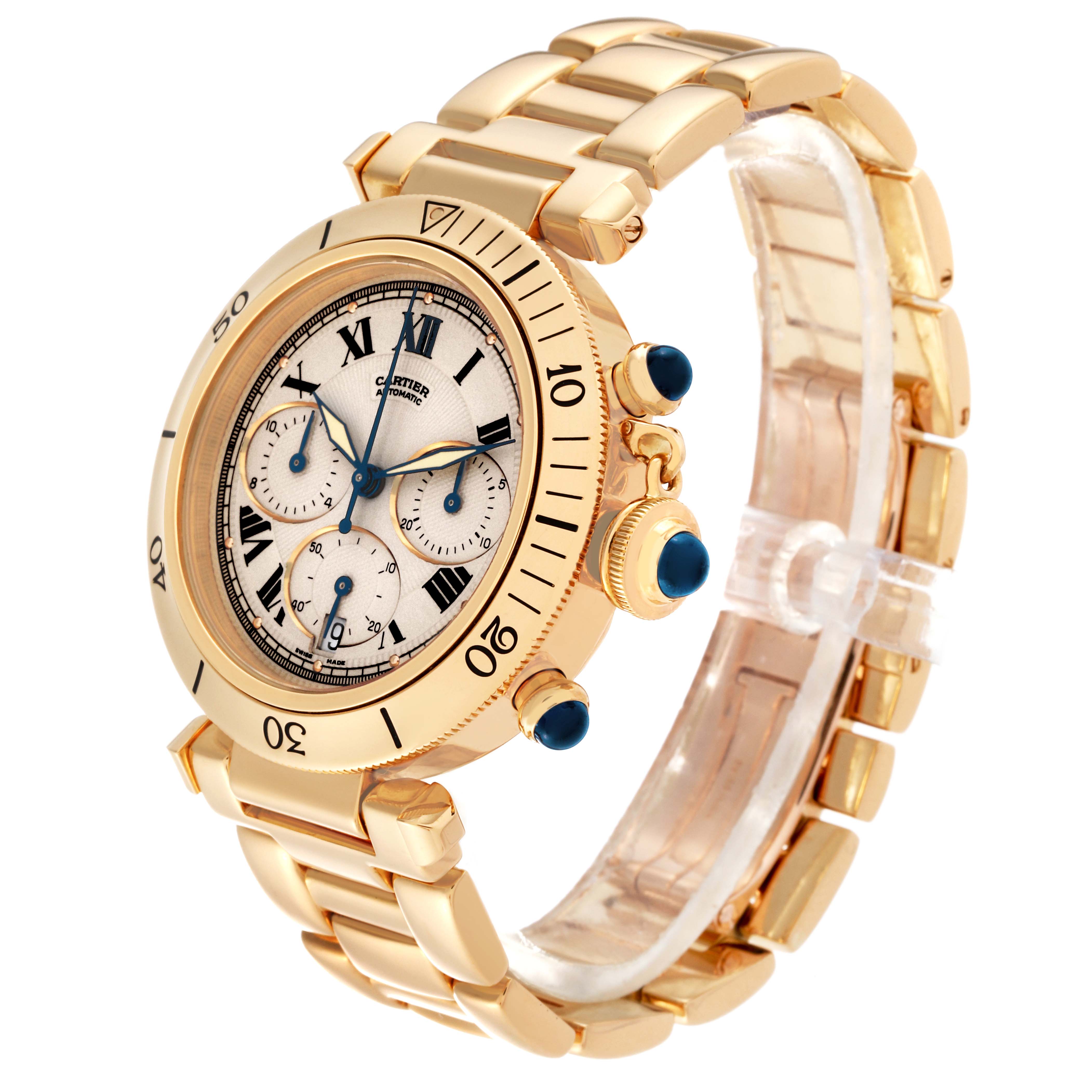 The image shows a side-angle view of a gold Cartier Pasha W524428 Men
s Yellow Gold Silver Dial W524428 Men
s Yellow Gold Silver Dial watch, highlighting its dial, bezel, strap, and blue gemstone crown.