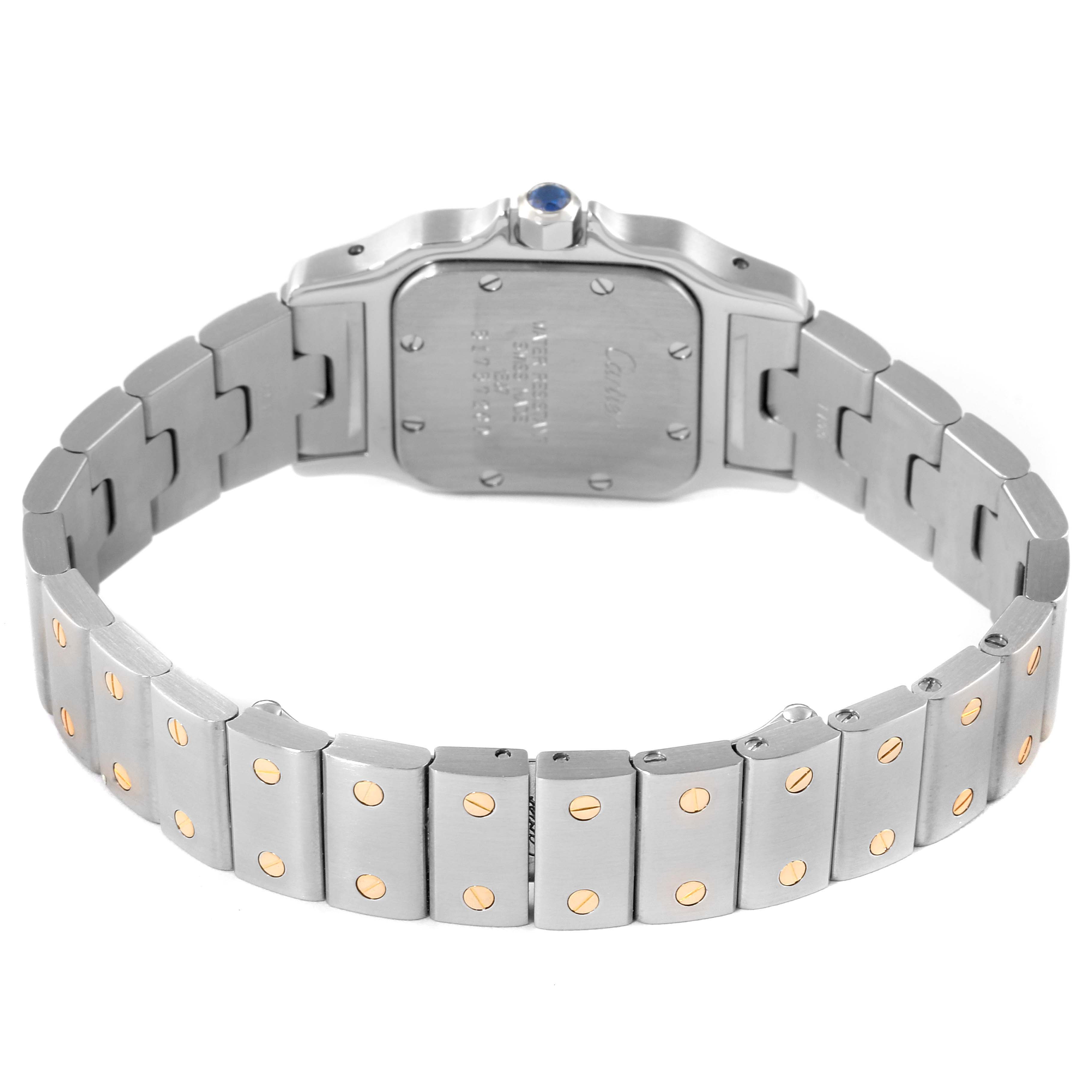 The image shows the back of a Santos model by Cartier, including the case back and part of the metal bracelet with gold screws.