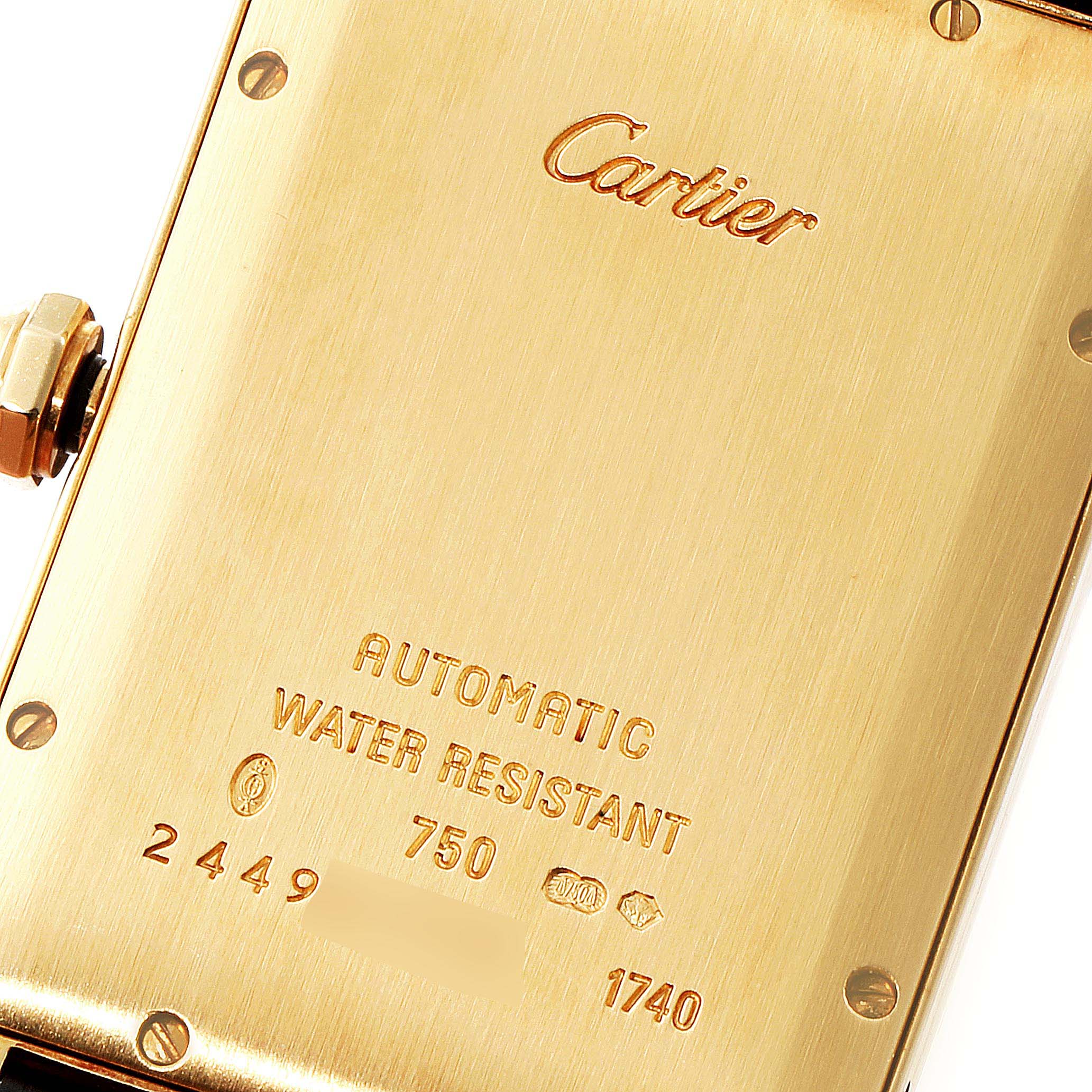 This image shows the backside of a Cartier Tank Americaine W2603156 Men
s Yellow Gold Silver Dial W2603156 Men
s Yellow Gold Silver Dial watch, highlighting the engraved details and markings.