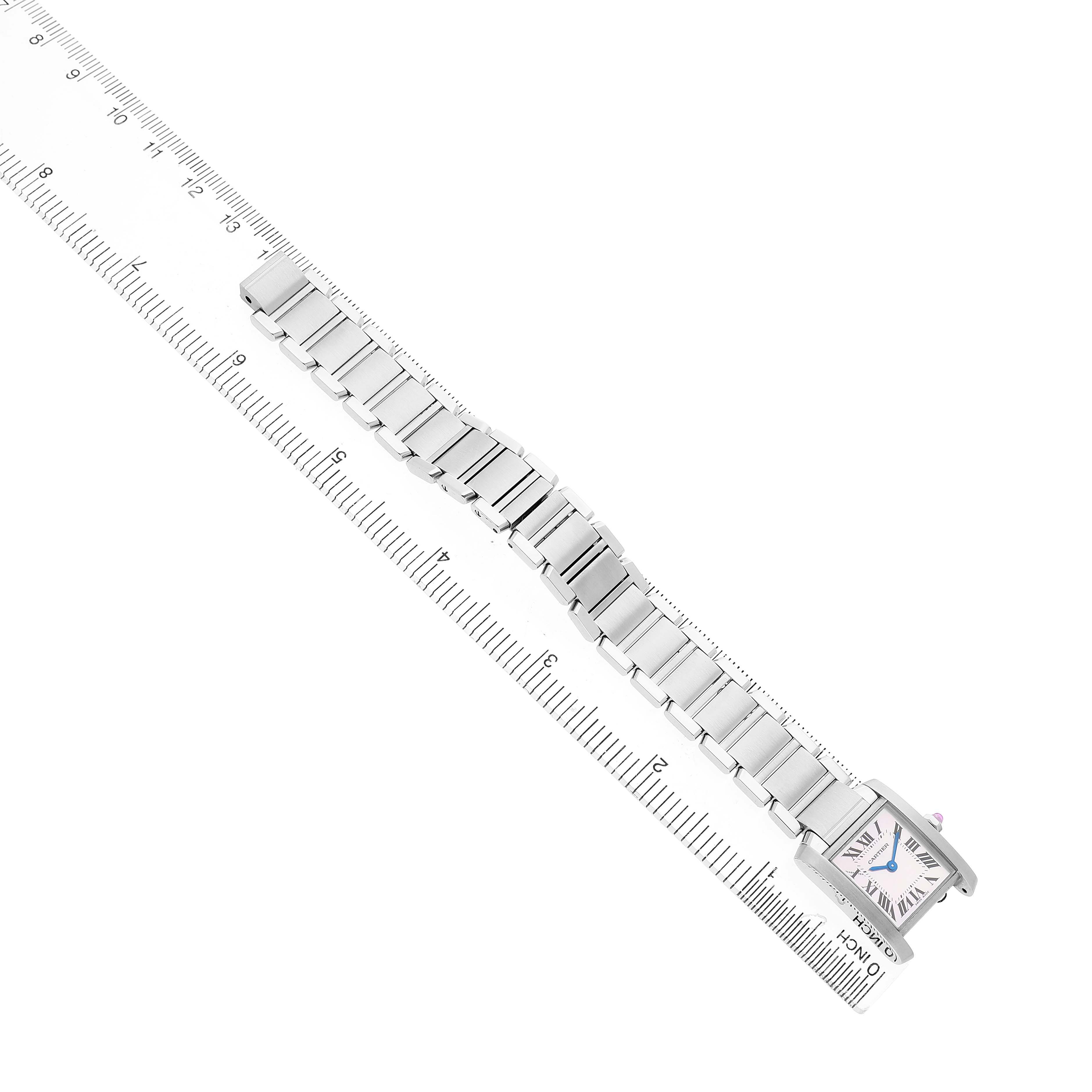 The image shows a Tank Française by Cartier from a top-down angle, displaying the full bracelet and watch face next to a ruler.