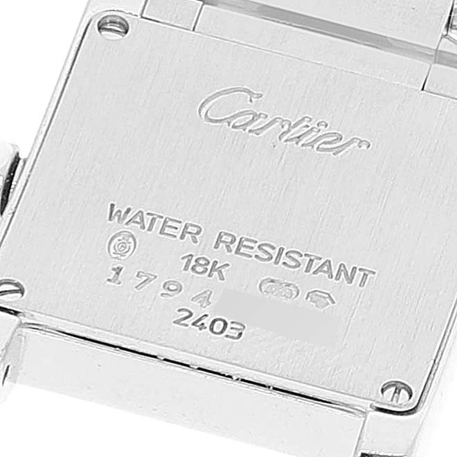 This image shows the backside of a Cartier Tank Francaise W50012S3 Women's White Gold Silver Dial W50012S3 Women's White Gold Silver Dial watch, displaying the branding, water resistance, and gold markings.