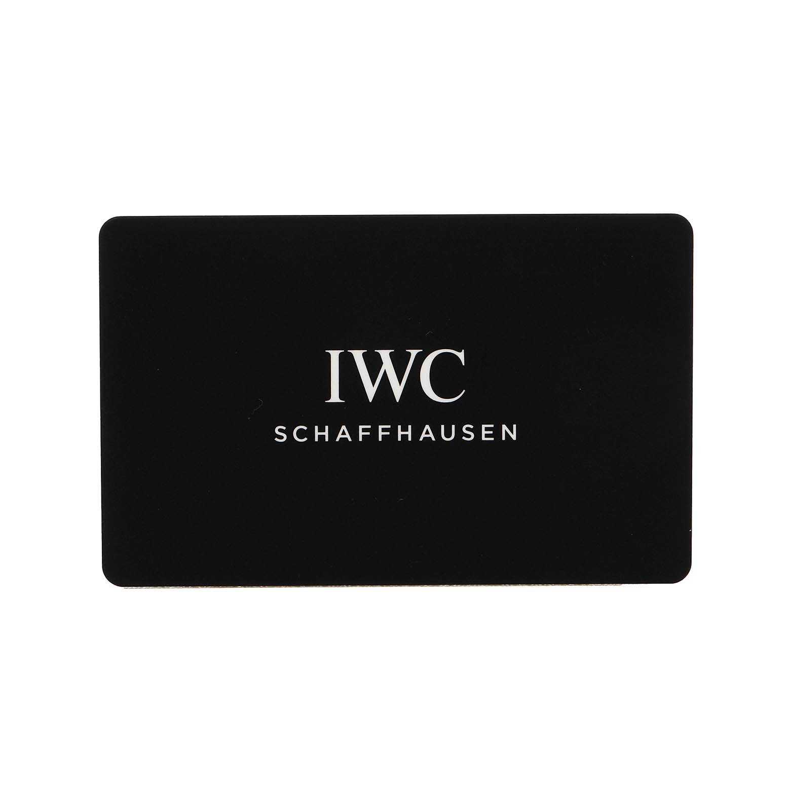 The image shows a black card with "IWC Schaffhausen" text, related to the IWC Pilot IW327006 Men's Titanium Black Dial watch model.
