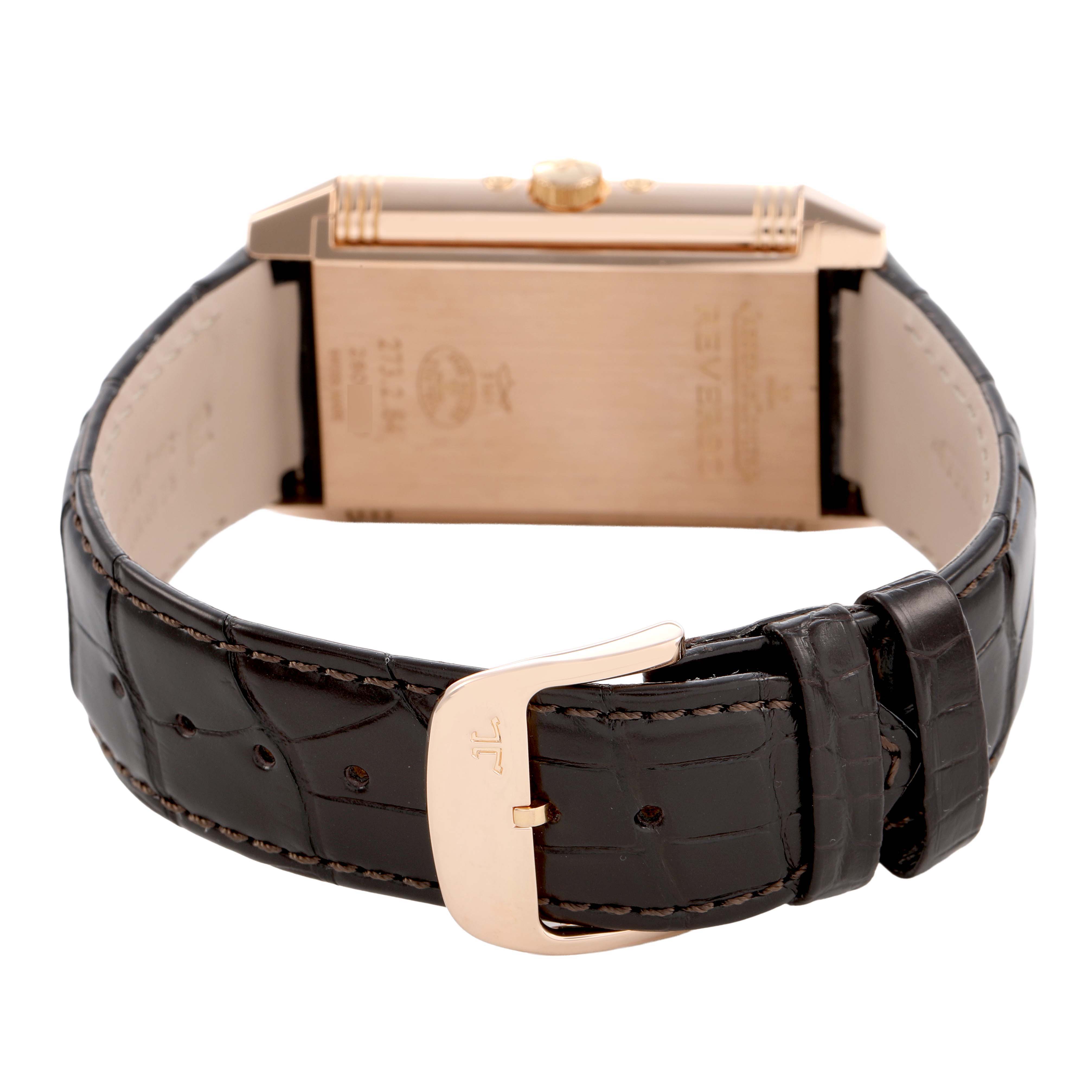 The Jaeger-LeCoultre Reverso watch is shown from the side and back, featuring the strap and clasp.