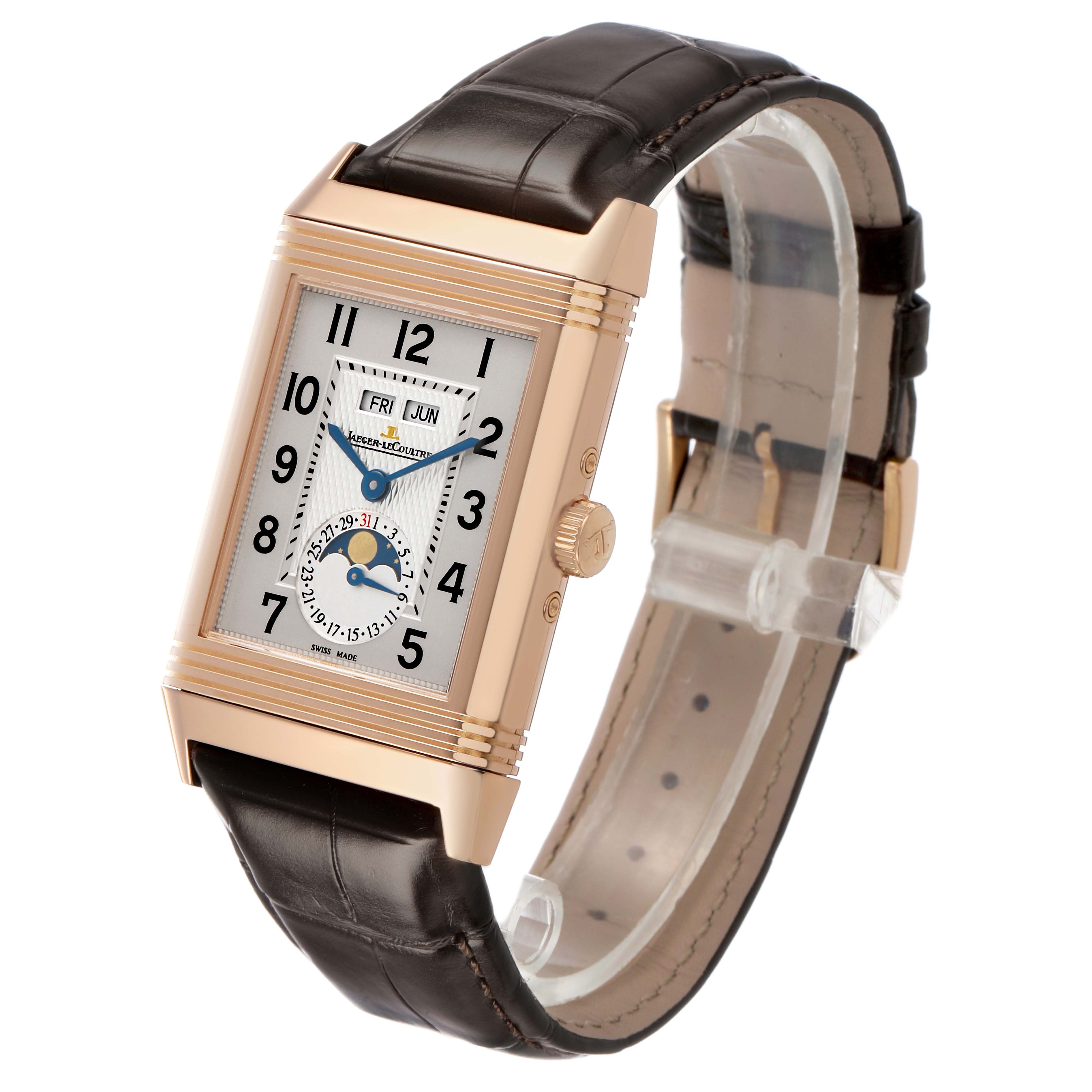 The Jaeger-LeCoultre Reverso watch is shown from a three-quarter angle, highlighting the dial, crown, and leather strap.