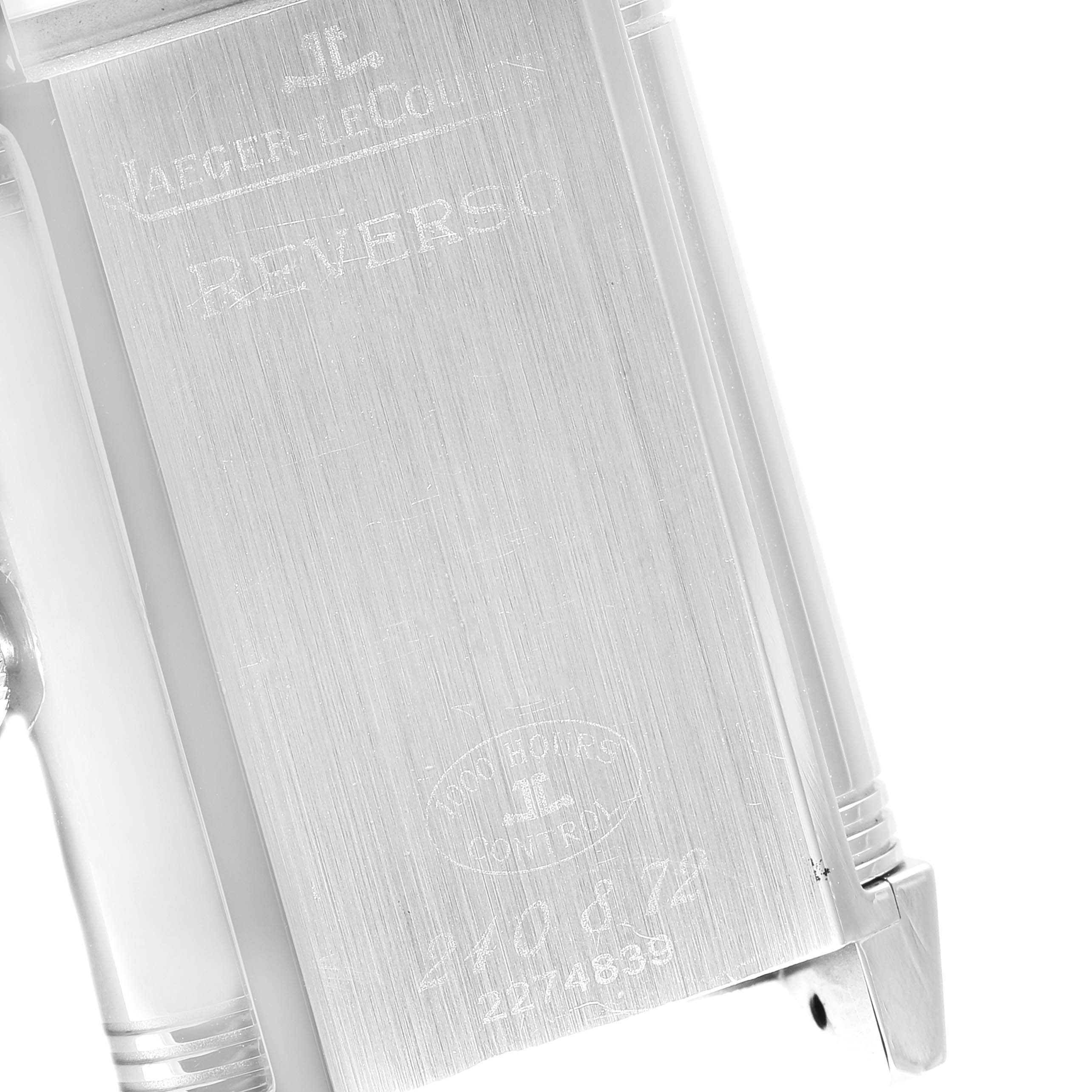 This image shows the engraved back of a Jaeger-LeCoultre Reverso watch, viewed at a slight angle.