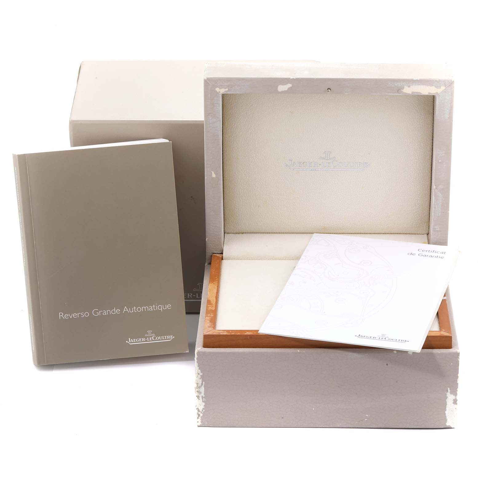 The image shows a Jaeger LeCoultre Reverso Q3038420 Men's Stainless Steel Silver Dial Q3038420 Men's Stainless Steel Silver Dial watch box, a certificate, and a user manual.