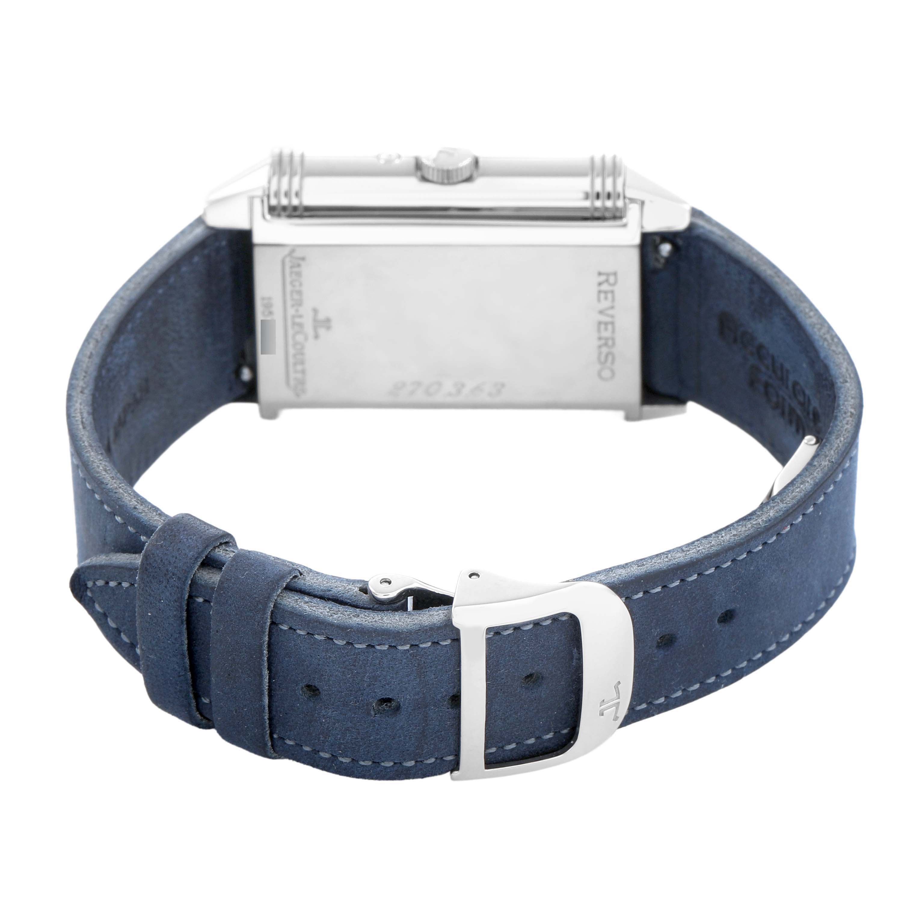 The Jaeger LeCoultre Reverso Q2753470 / 270.3.63 Men's White Gold Black Dial watch is shown from the back, highlighting the case back, crown, and blue leather strap with buckle.