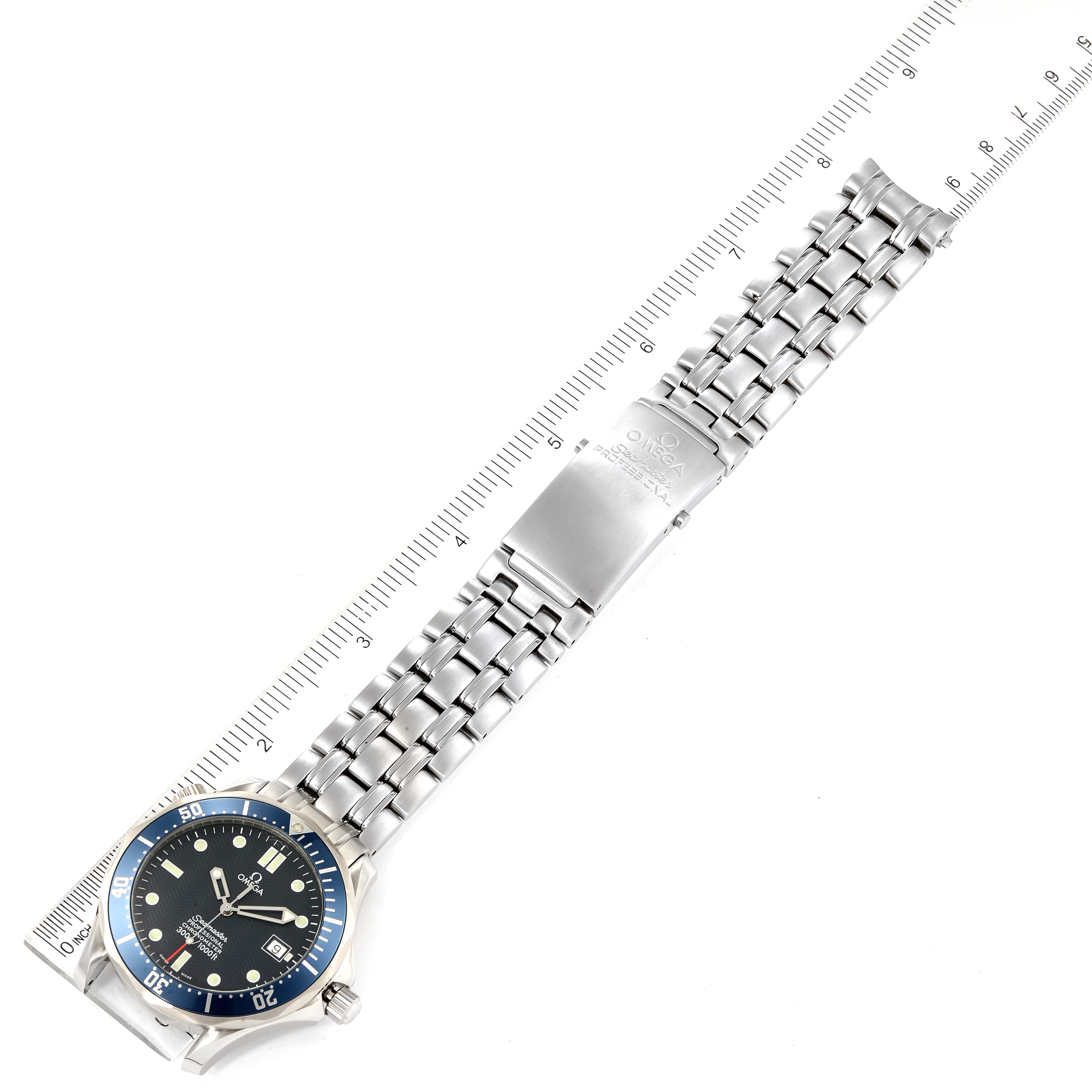 The Omega Seamaster 2531.80.00 Men's Stainless Steel Blue Dial 2531.80.00 Men's Stainless Steel Blue Dial watch is shown from the top, displaying the face, bezel, and the full length of the metal bracelet alongside a ruler.