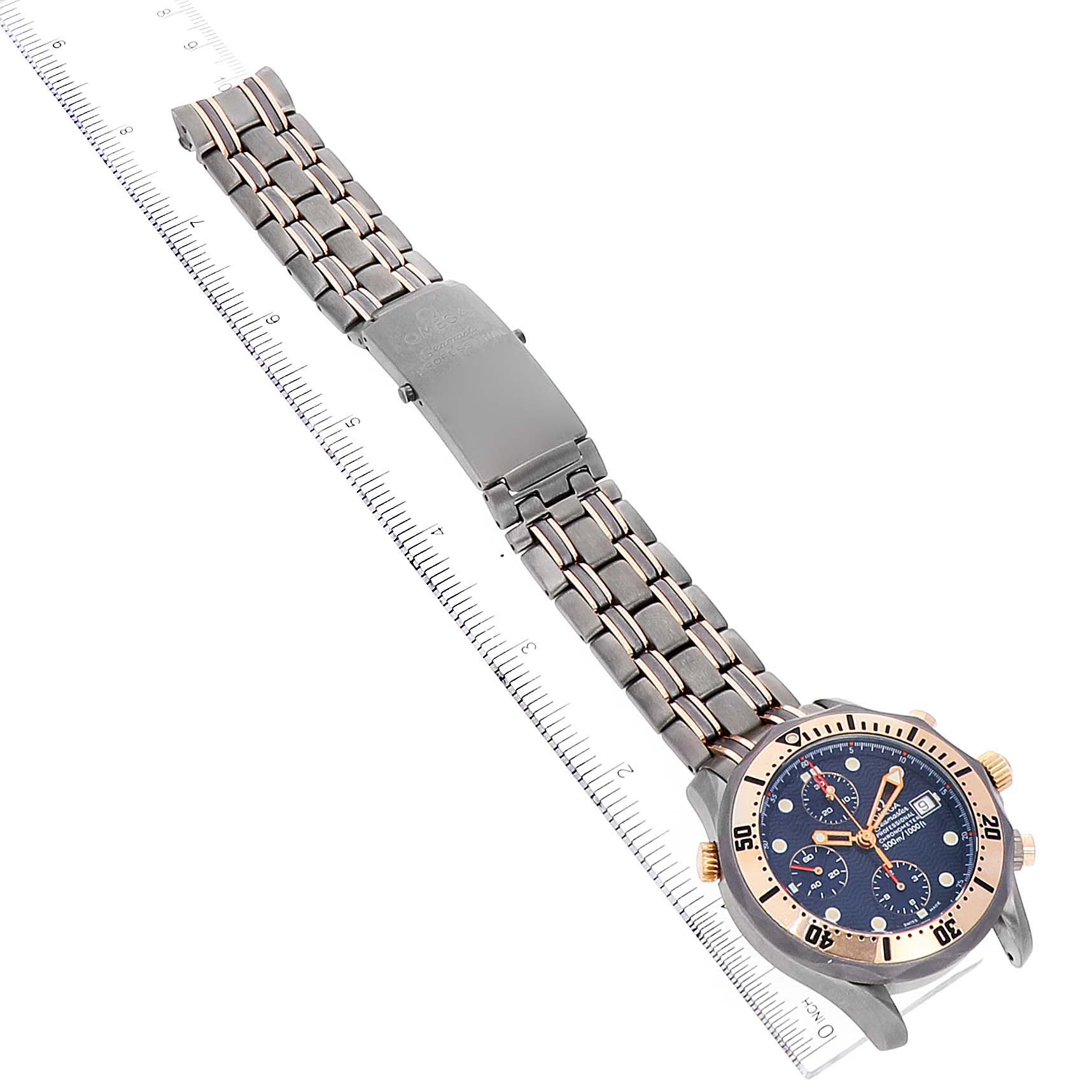 The image shows the face and band of an Omega Seamaster 2296.80.00 Men's Titanium Blue Dial 2296.80.00 Men's Titanium Blue Dial watch, displayed diagonally with a ruler alongside it.