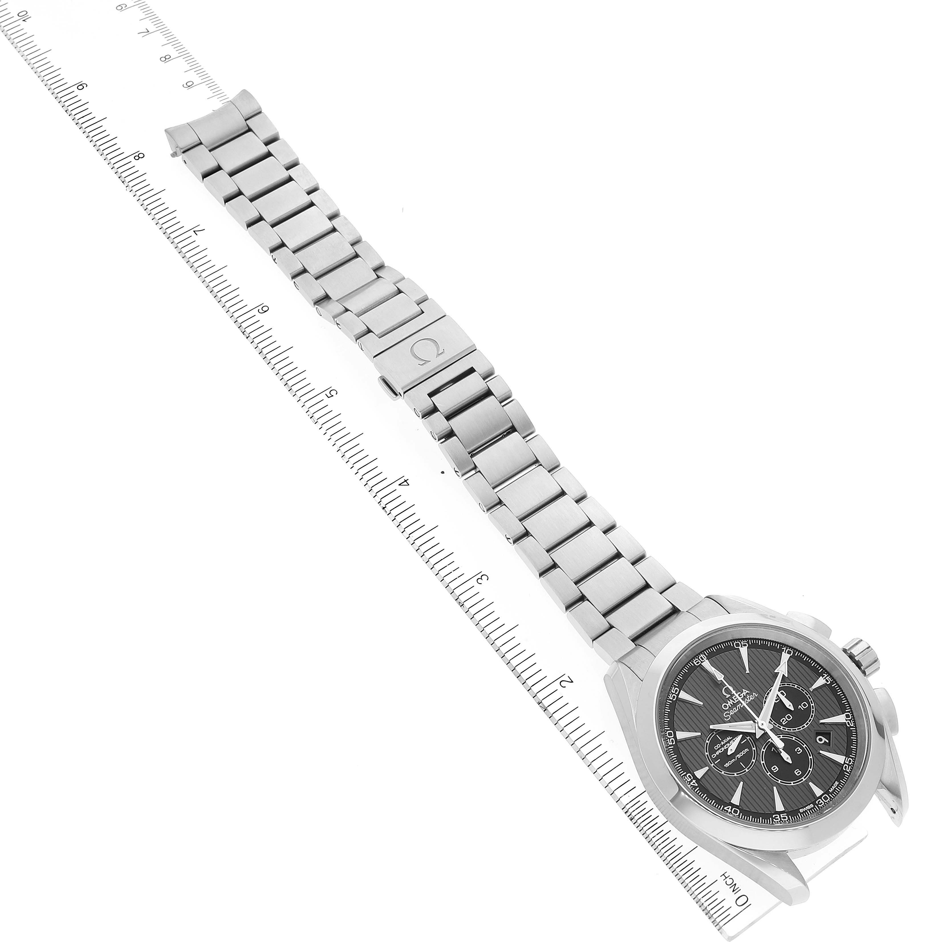 The image shows an angled view of an Omega Aqua Terra 231.12.44.50.06.001 Men's Stainless Steel Grey Dial 231.12.44.50.06.001 Men's Stainless Steel Grey Dial watch, displaying the bracelet, clasp, and watch face with a ruler for scale.