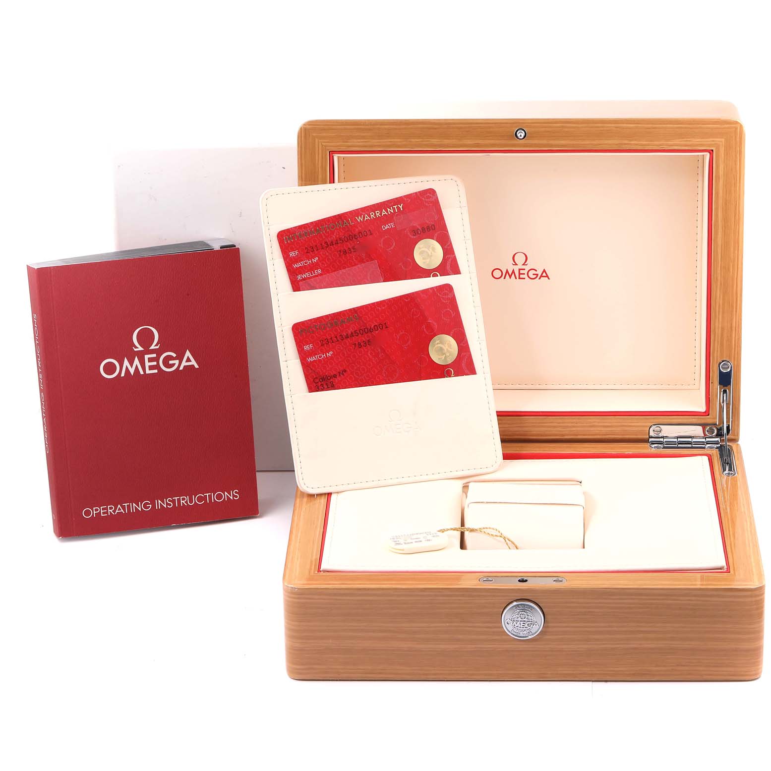 The image shows the accessories of the Omega Aqua Terra 231.12.44.50.06.001 Men's Stainless Steel Grey Dial 231.12.44.50.06.001 Men's Stainless Steel Grey Dial model, including the warranty cards, operating instructions, and a wooden box.