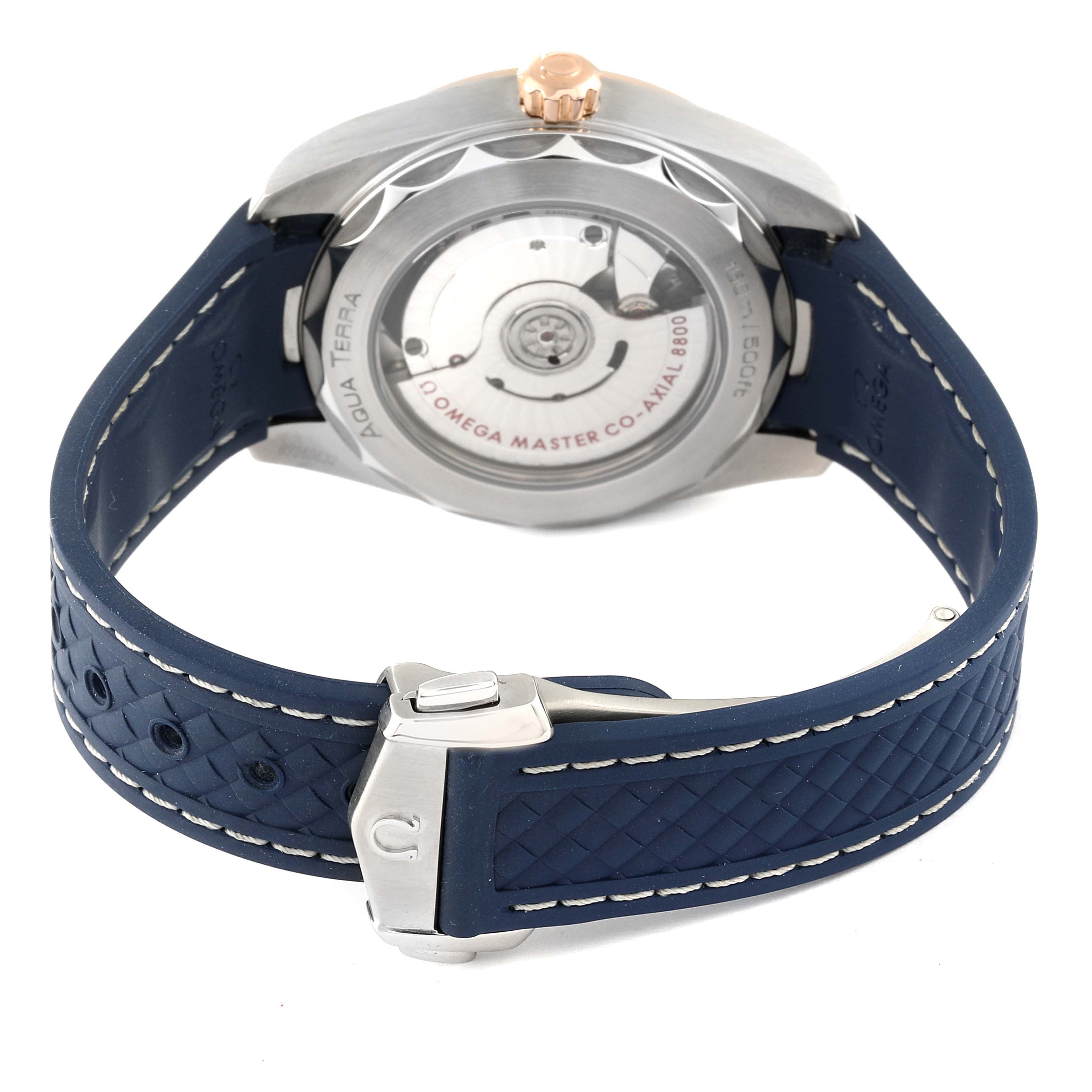 The image shows the back of the Omega Aqua Terra 220.23.38.20.03.001 Men's Steel and Gold (two tone) Blue Dial 220.23.38.20.03.001 Men's Steel and Gold (two tone) Blue Dial watch, highlighting its case back, movement, and blue strap with a buckle.