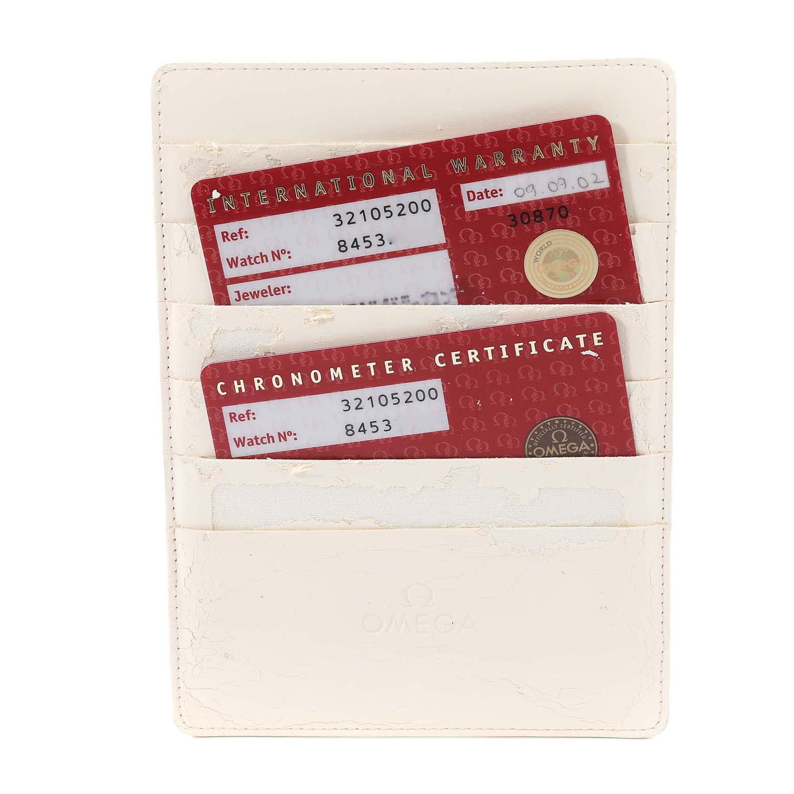 This image shows the international warranty and chronometer certificate cards for an Omega Speedmaster 3210.52.00 Men
s Stainless Steel Black Dial 3210.52.00 Men
s Stainless Steel Black Dial watch in a white cardholder.