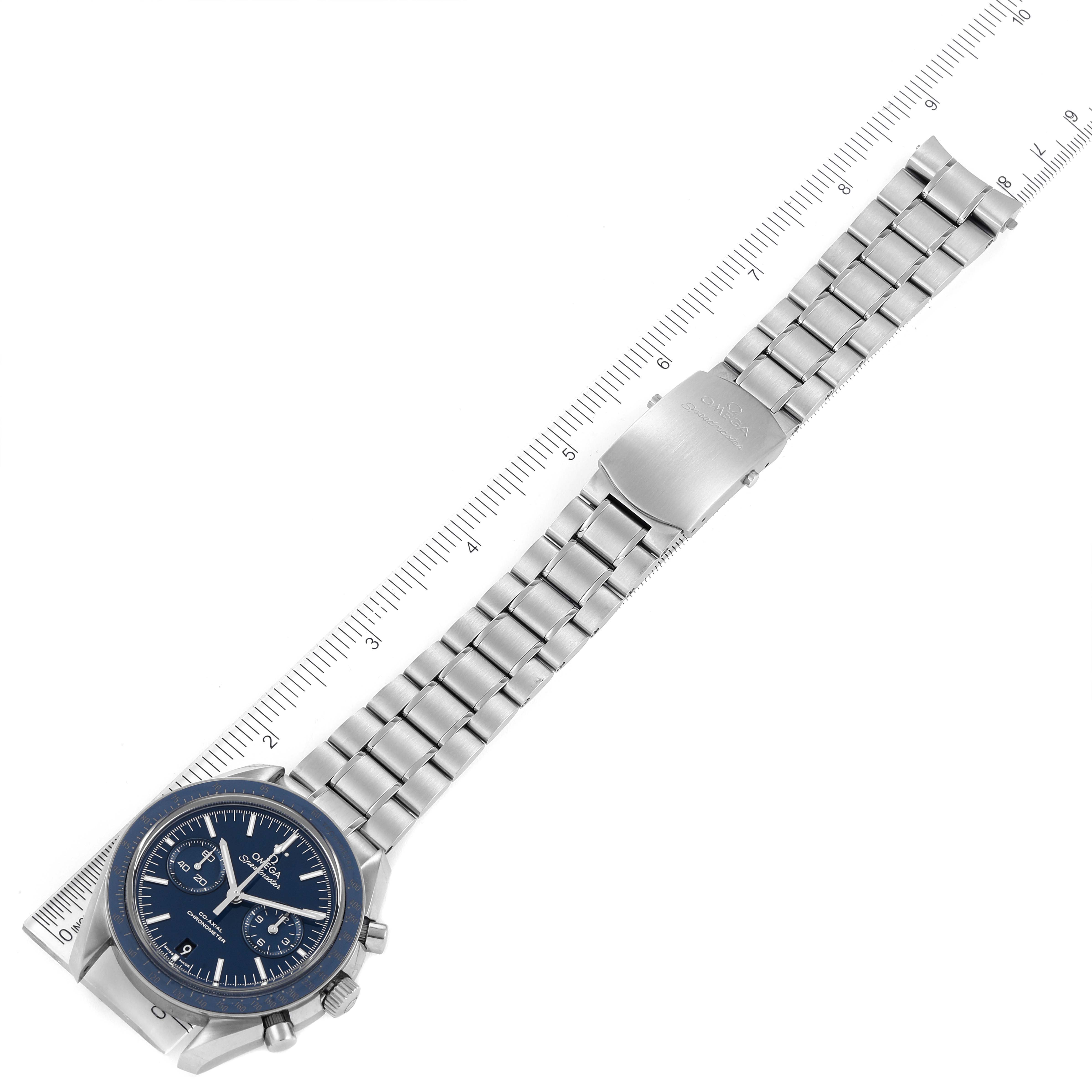 The image shows an Omega Speedmaster 311.90.44.51.03.001 Men's Titanium Blue Dial 311.90.44.51.03.001 Men's Titanium Blue Dial watch laid flat with its face, bracelet, and clasp visible, alongside a ruler for scale.