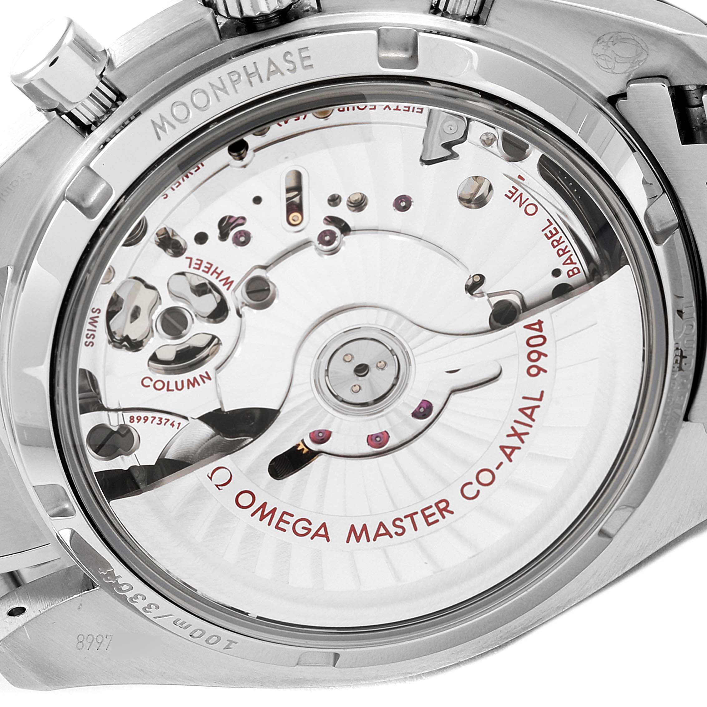 The image shows the case back of an Omega Speedmaster 304.30.44.52.01.001 Men's Stainless Steel Black Dial 304.30.44.52.01.001 Men's Stainless Steel Black Dial, revealing its intricate movement and "Omega Master Co-Axial 9904" inscription.