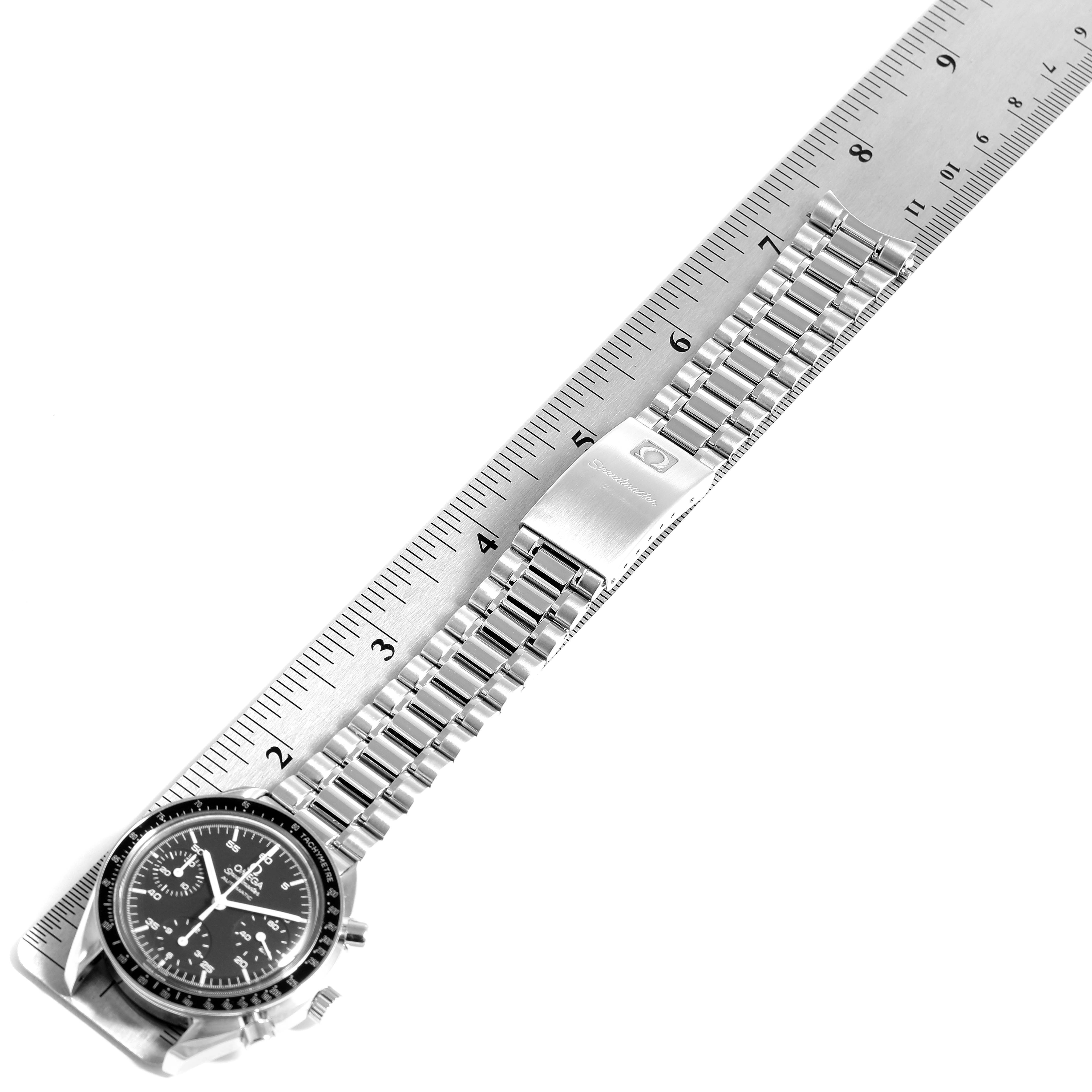 The image shows an Omega Speedmaster 3510.50.00 Men's Stainless Steel Black Dial 3510.50.00 Men's Stainless Steel Black Dial watch laid flat, with its stainless steel bracelet aligned against a ruler.