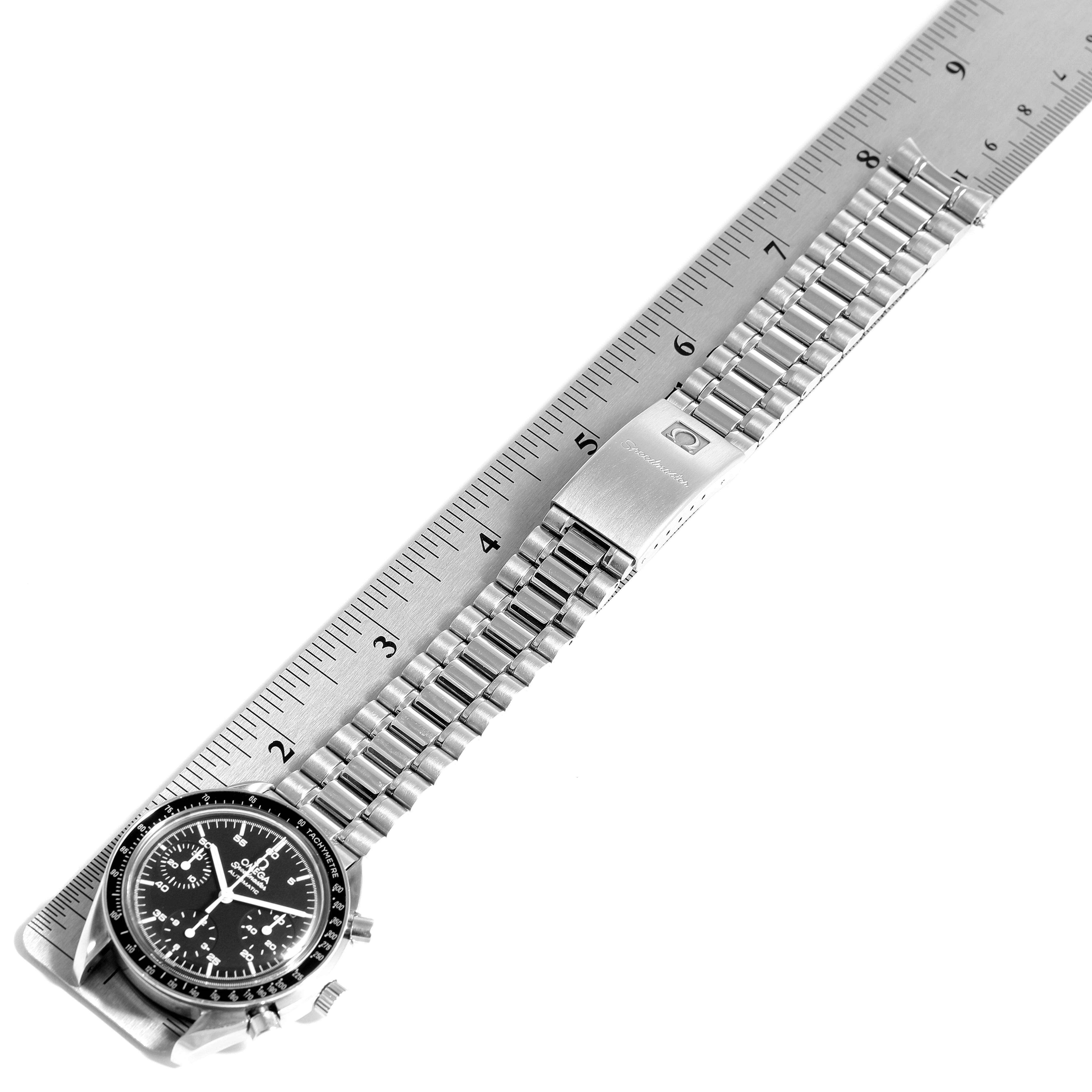 The image shows an Omega Speedmaster 3510.50.00 Men
s Stainless Steel Black Dial 3510.50.00 Men
s Stainless Steel Black Dial watch with its full length stainless steel bracelet and clasp, measured against a ruler.