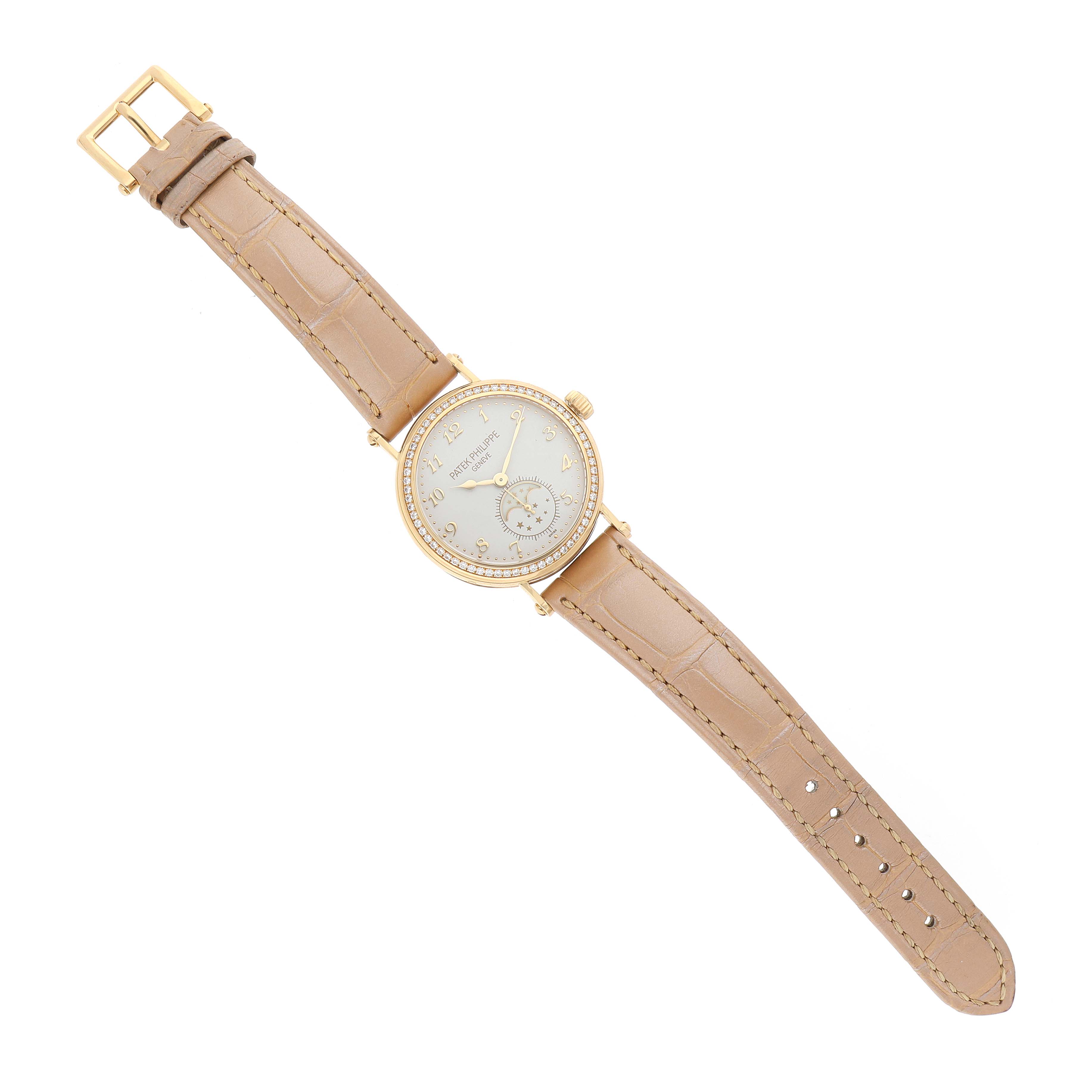 The Patek Philippe Calatrava 7121J-001 Women's Yellow Gold Silver Dial watch is shown from a top-down angle, showcasing the dial, bezel, lugs, and beige strap.