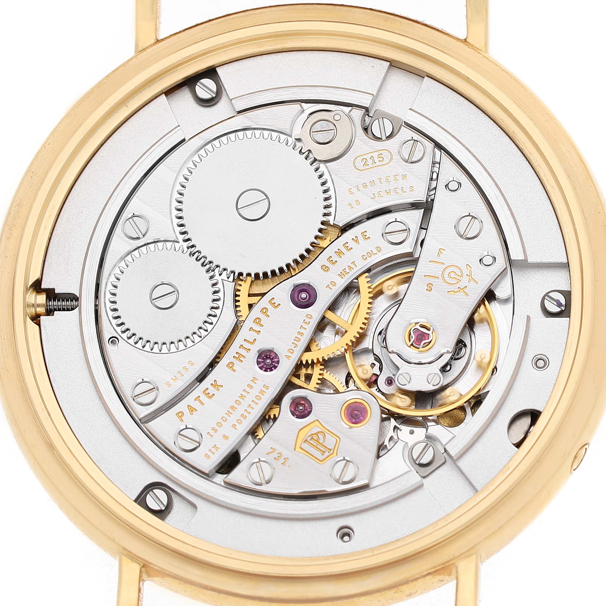 The image shows the intricate rear view of the Patek Philippe Calatrava 7121J-001 Women's Yellow Gold Silver Dial’s movement, highlighting gears and mechanical details.