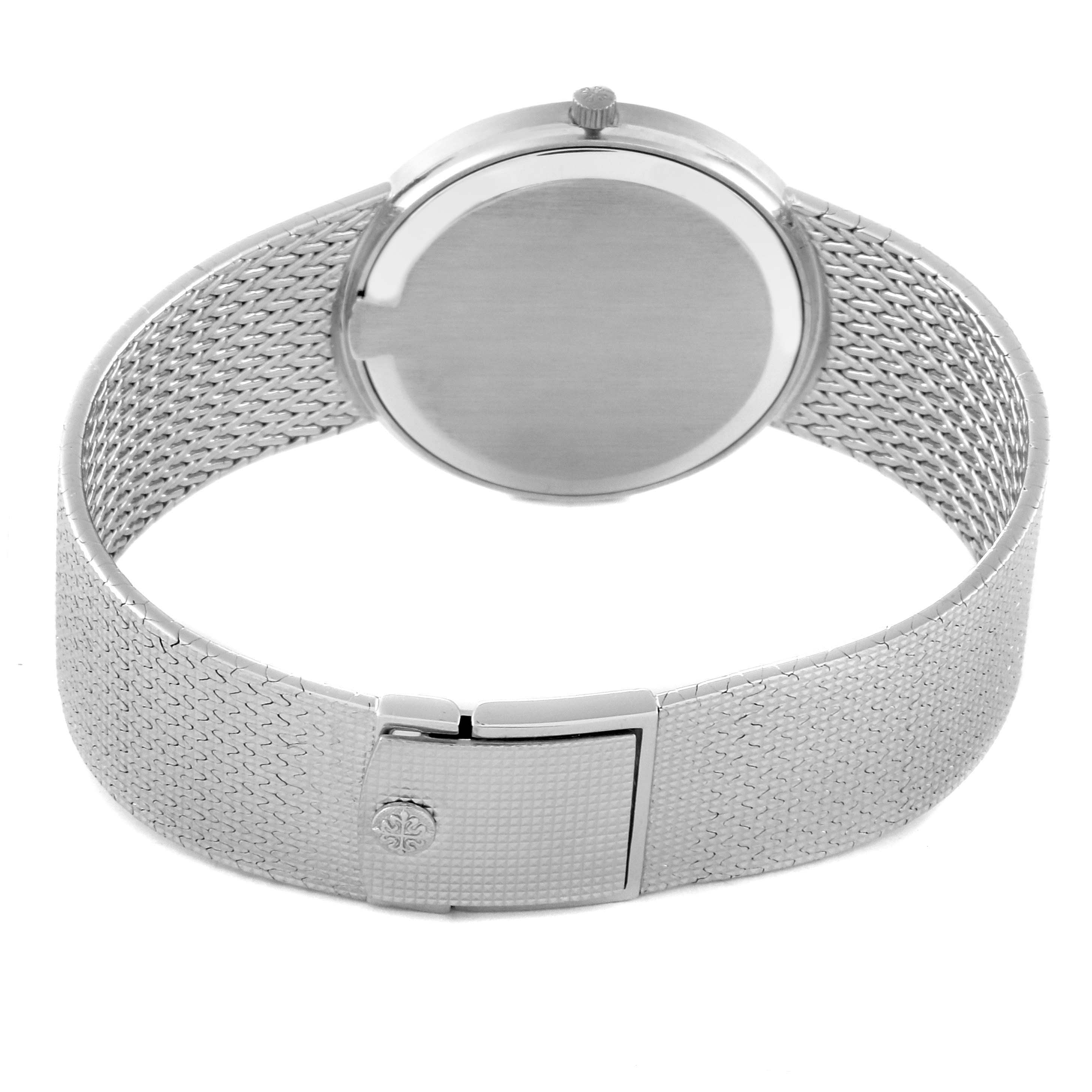 The image shows the back and strap of a Calatrava model by Patek Philippe, with a focus on the mesh bracelet and clasp.