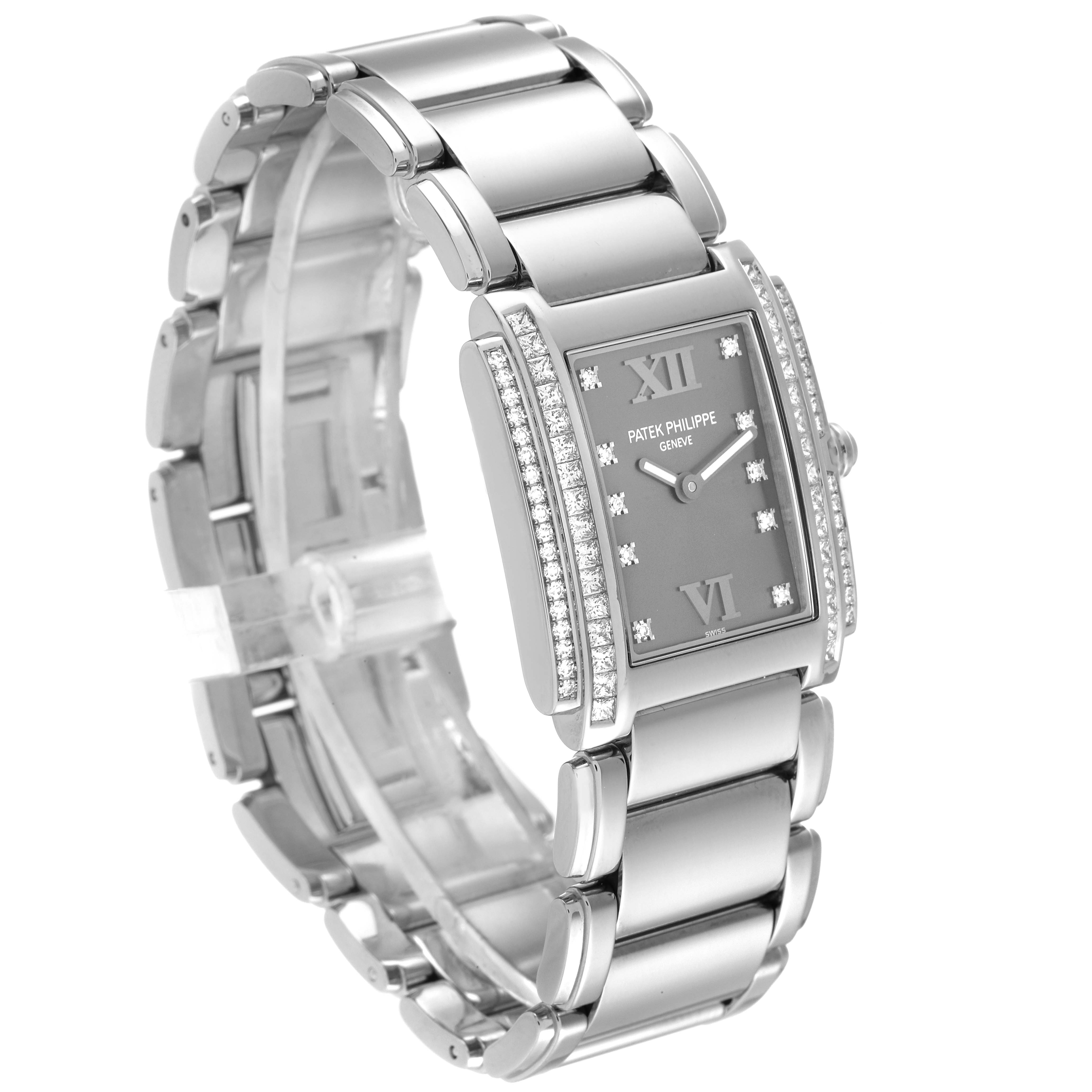 The image shows a Patek Philippe Twenty-4 4910/20 Women's White Gold Grey Dial 4910/20 Women's White Gold Grey Dial watch viewed at an angle displaying its face, bracelet, and diamond embellishments.