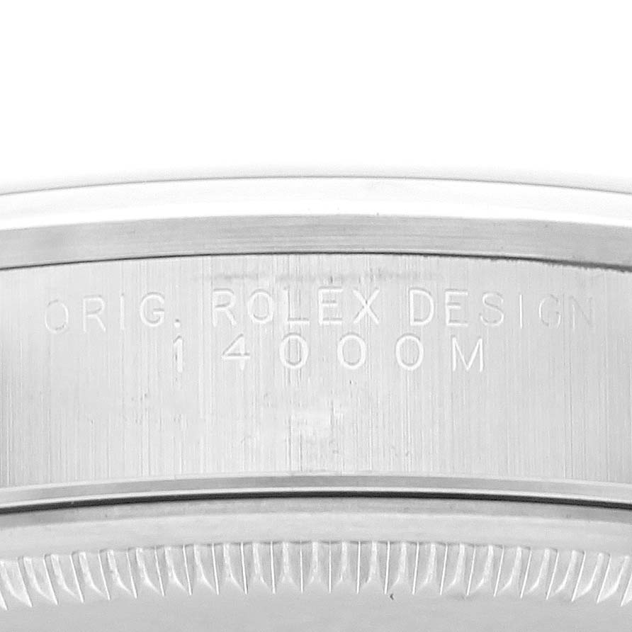 This image shows a close-up of the case back engraving on a Rolex Air-King 14000 Men's Stainless Steel Silver Dial 14000 Men's Stainless Steel Silver Dial model, displaying the serial numbers and "Rolex Design" inscription.