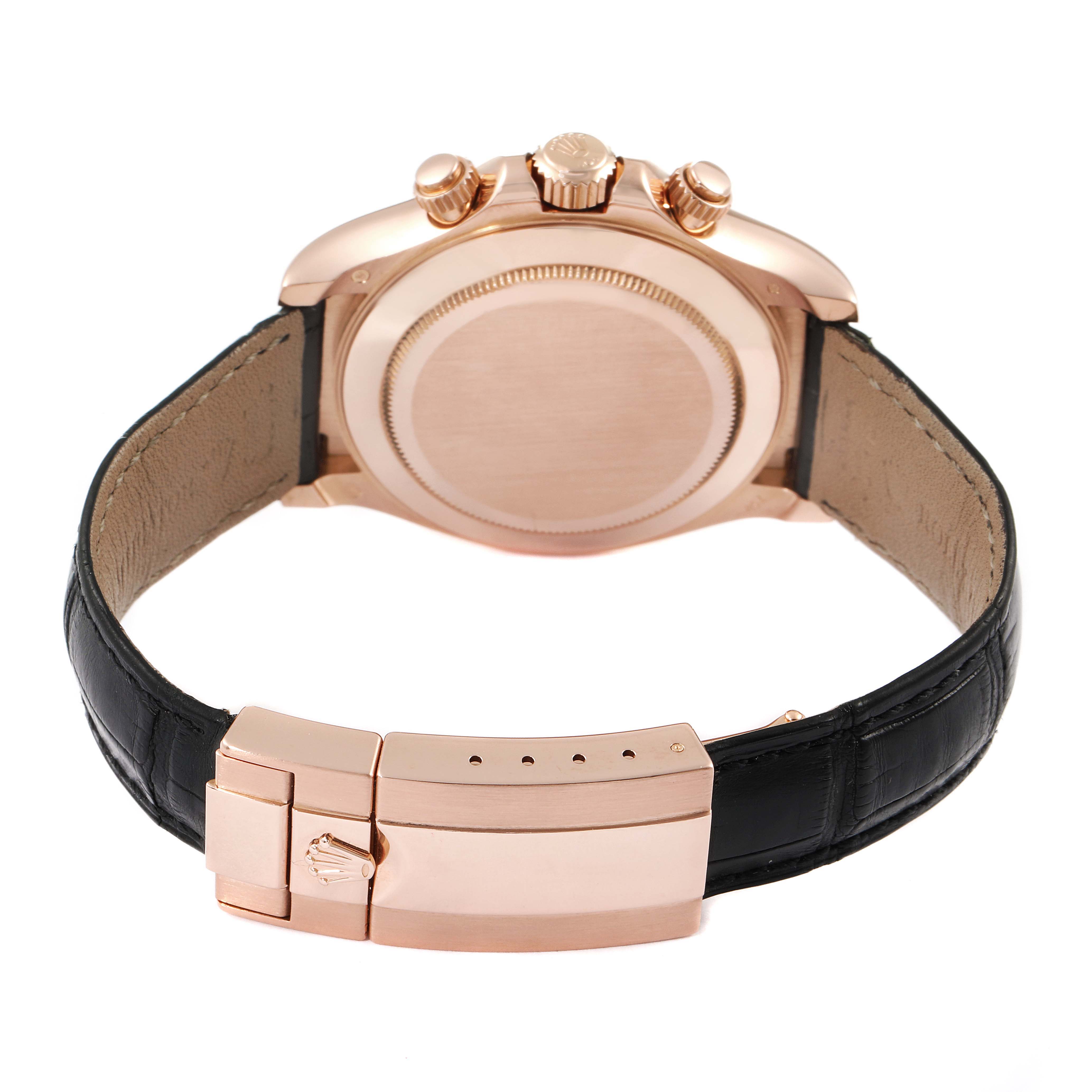 The image shows the back of a Rolex Daytona 116515LN Men's Rose Gold Silver Dial 116515LN Men's Rose Gold Silver Dial watch with its clasp and crown, featuring a leather strap.