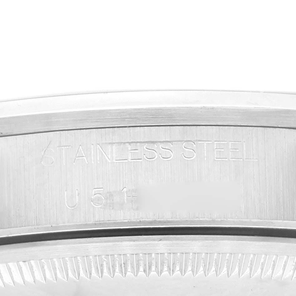 The image shows a close-up of the case back edge with engraved text of a Rolex Date 15200 Men's Stainless Steel White Dial 15200 Men's Stainless Steel White Dial model watch in stainless steel.