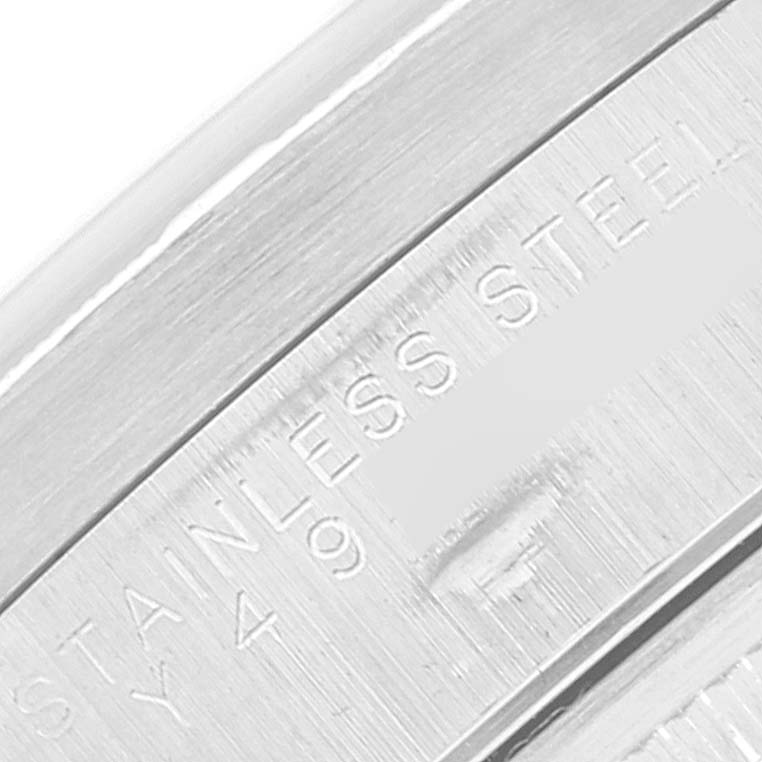 This is a close-up shot of the inner bezel or case part of the Rolex Date 15210 Men's Stainless Steel Silver Dial 15210 Men's Stainless Steel Silver Dial model, showcasing its stainless steel engraving.