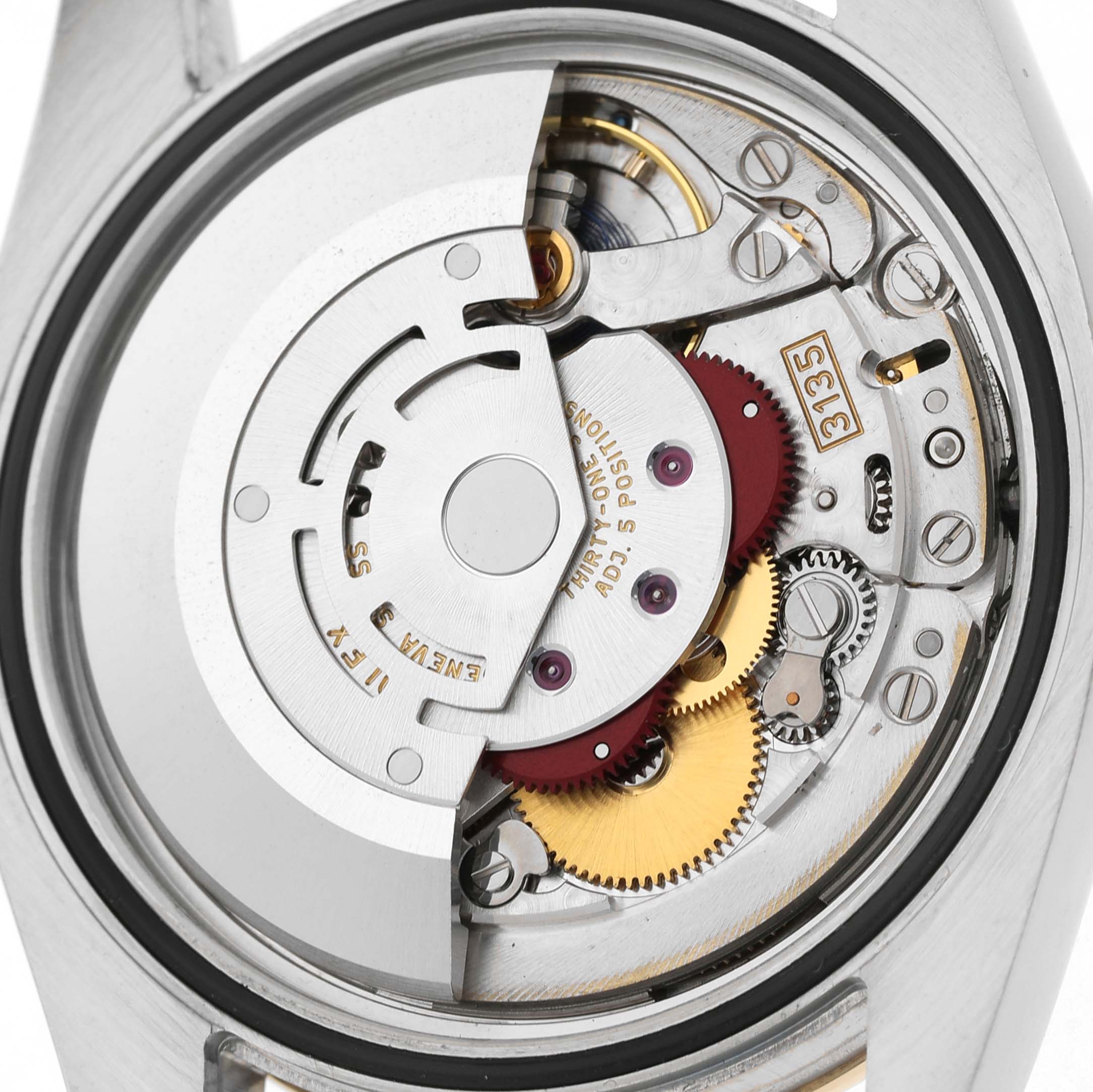 The image shows a close-up of the movement inside a Rolex Datejust 116243 Men's Steel and Gold (two tone) Champagne Dial, highlighting gears and the rotor.