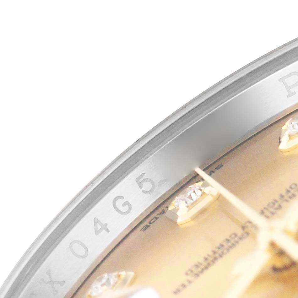 The image shows a close-up angled view of the Rolex Datejust 116243 Men's Steel and Gold (two tone) Champagne Dial watch's dial, highlighting diamond hour markers and part of the bezel.