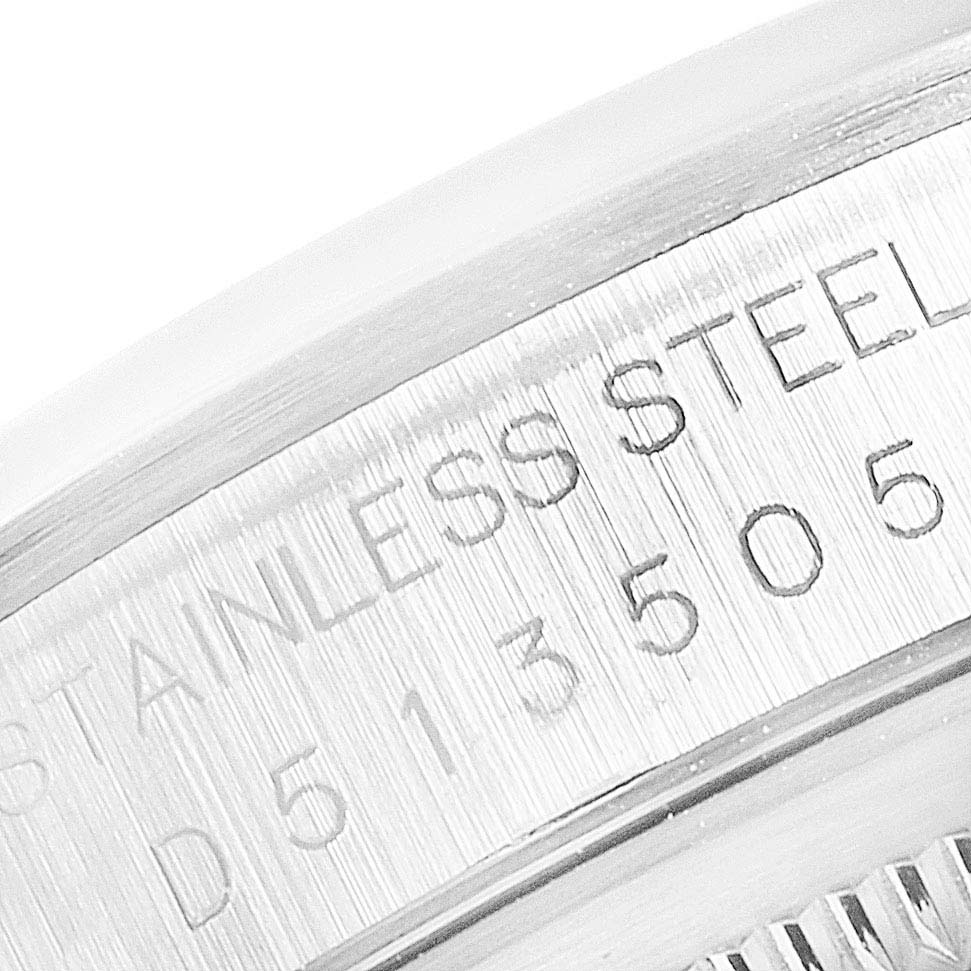 This close-up image of a Rolex Datejust 16200 Men's Stainless Steel Silver Dial 16200 Men's Stainless Steel Silver Dial watch shows the engraved serial number on the stainless steel case.