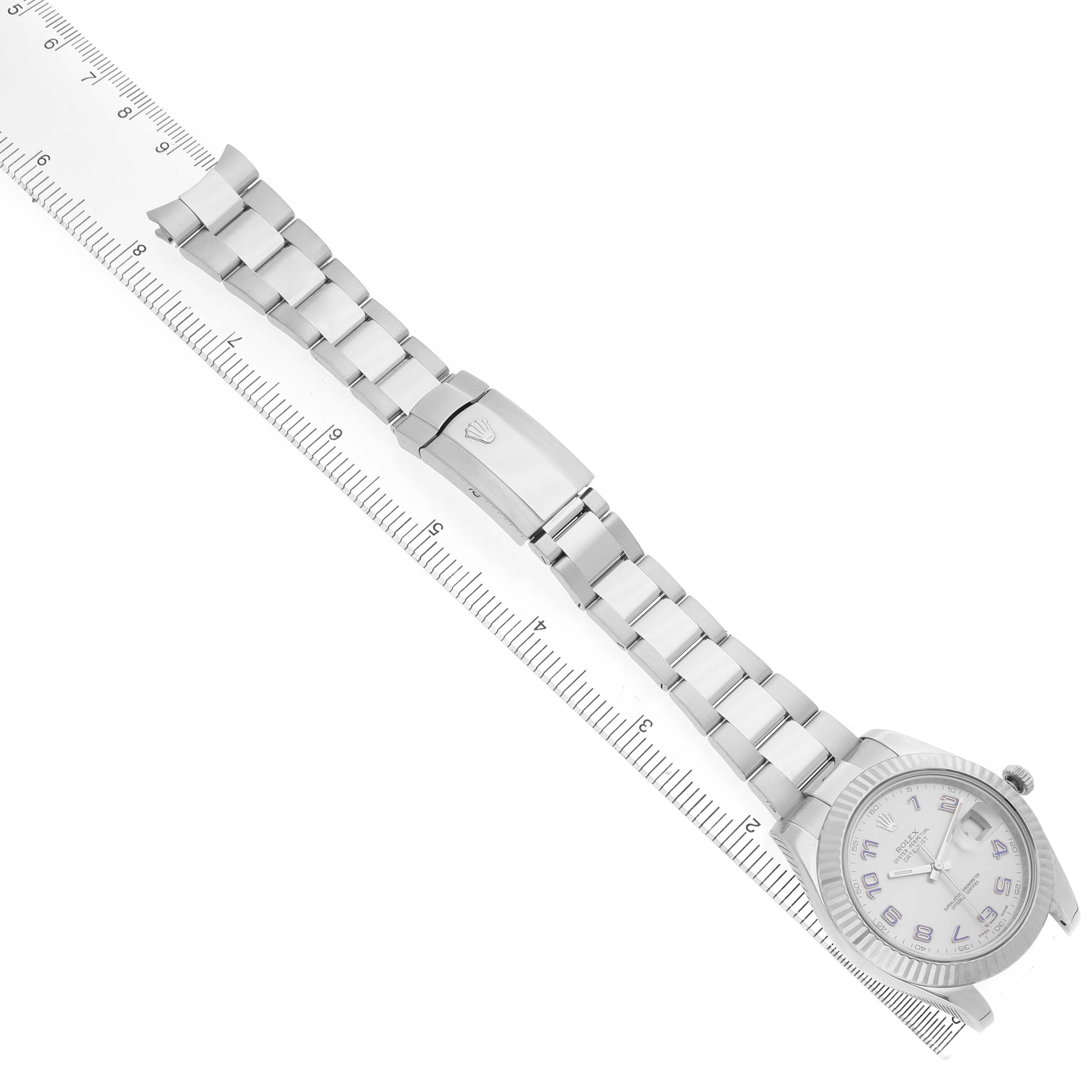 The Rolex Datejust 41 116334 Men's Stainless Steel Silver Dial watch is displayed from an overhead angle, showing the full bracelet and the clasp alongside a ruler for scale.