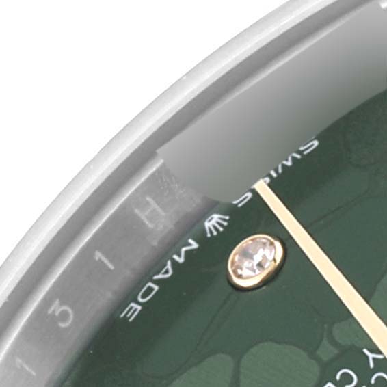 Close-up of a Rolex Mid-Size 278343RBR Women's Steel and Gold (two tone) Green Dial 278343RBR Women's Steel and Gold (two tone) Green Dial model, showing the edge of the dial, a diamond marker, and partial "Swiss Made" text.