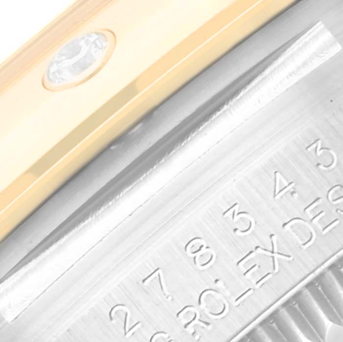 The image shows a close-up of the side detailing and partial serial number engraving of a Rolex Mid-Size 278343RBR Women's Steel and Gold (two tone) Green Dial 278343RBR Women's Steel and Gold (two tone) Green Dial watch.