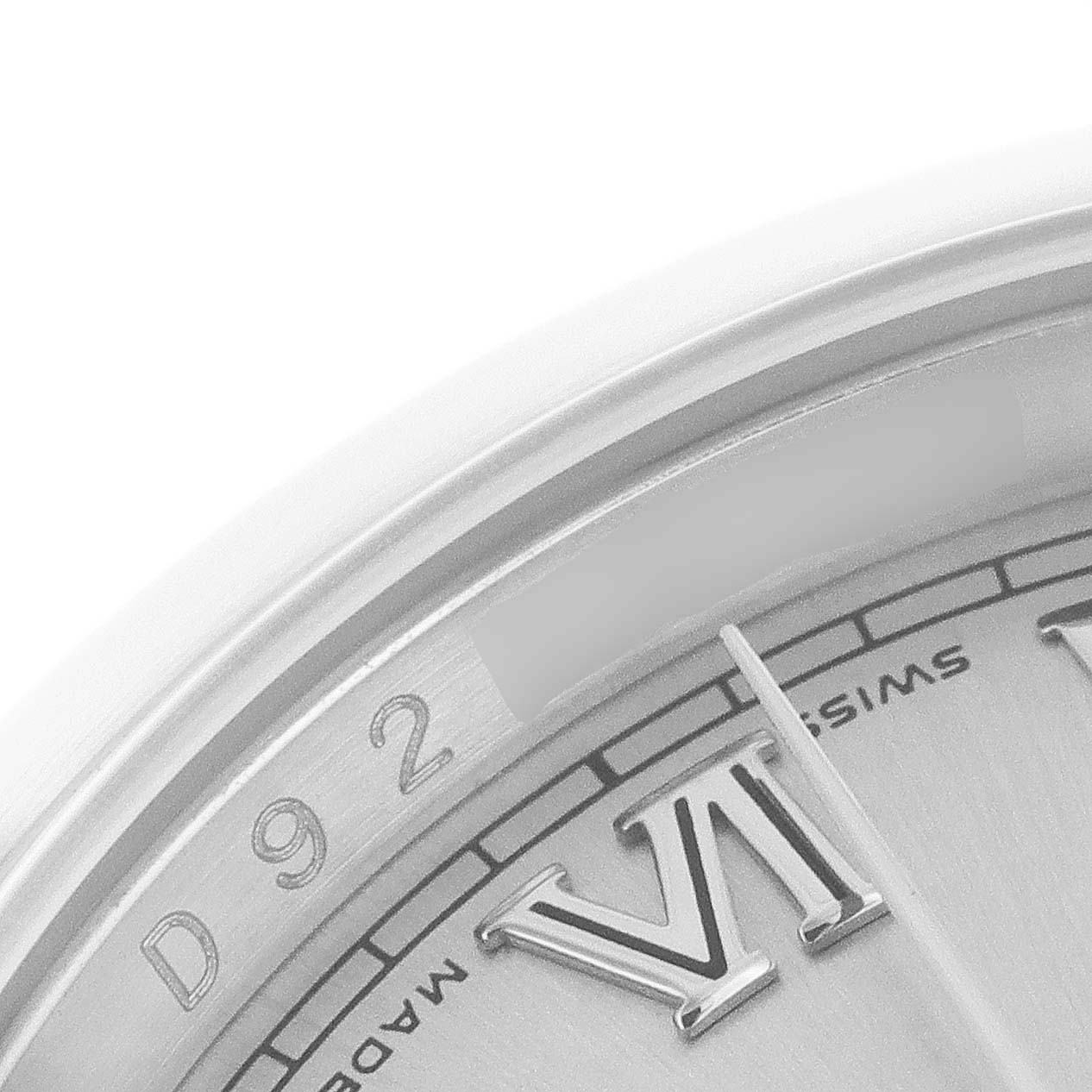 This image shows a close-up view of the dial and part of the bezel of a Rolex Datejust 116200 Men's Stainless Steel Silver Dial 116200 Men's Stainless Steel Silver Dial watch, highlighting the Roman numeral "VI" and some inscriptions.