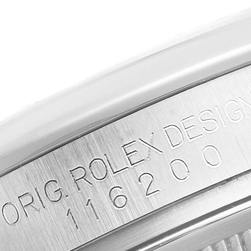 The image shows a close-up of the engraved original Rolex design and model number on the side of a Rolex Datejust 116200 Men's Stainless Steel Silver Dial 116200 Men's Stainless Steel Silver Dial watch.