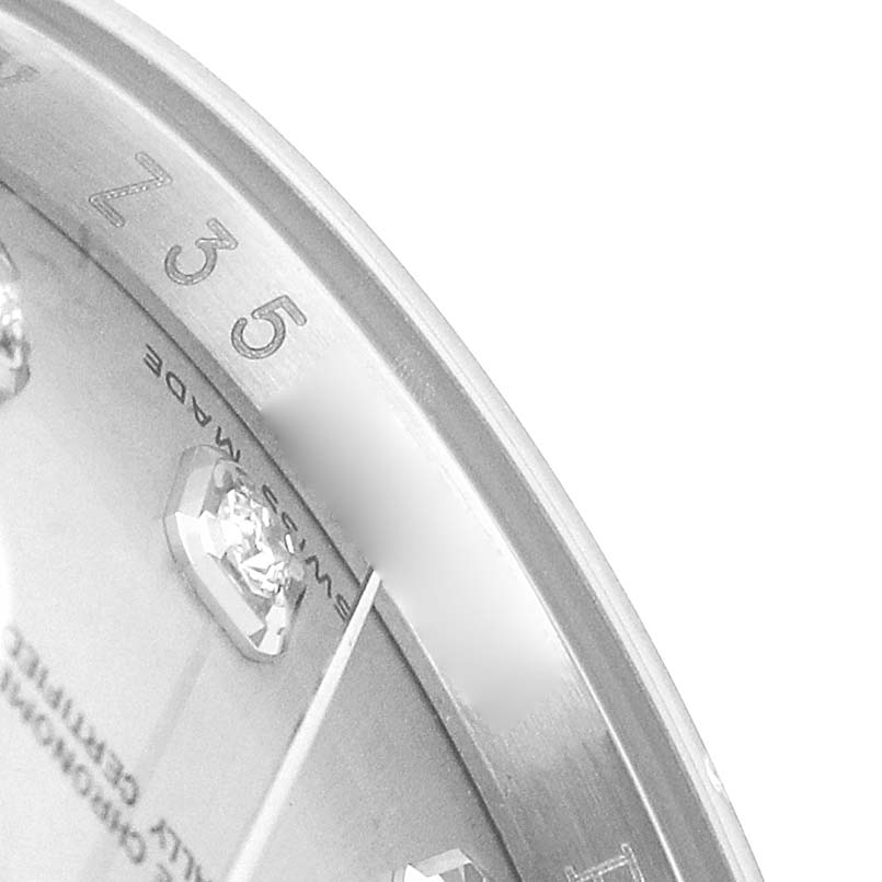 The close-up angle of the Rolex Datejust 116234 Men's Stainless Steel Silver Dial shows part of the dial, diamonds, and etched bezel markings.