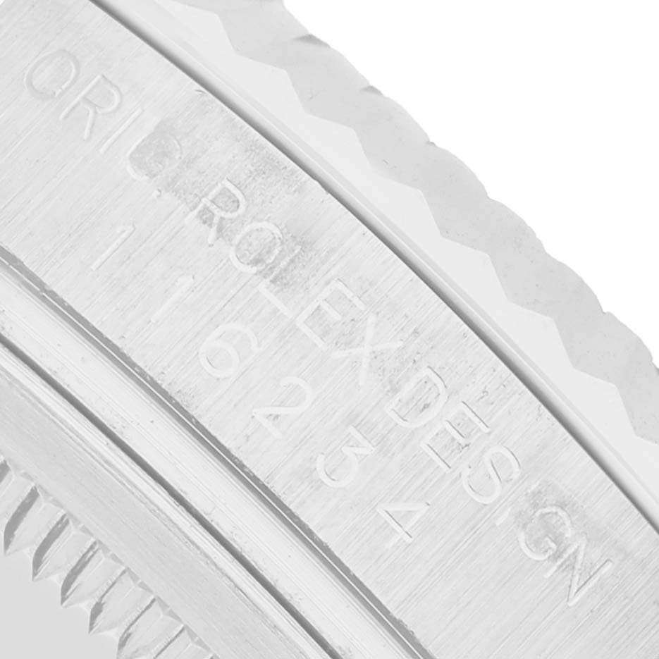 The image shows a close-up of the bezel and case side of a Rolex Datejust 116234 Men's Stainless Steel Silver Dial, displaying the engravings on the metal surface.