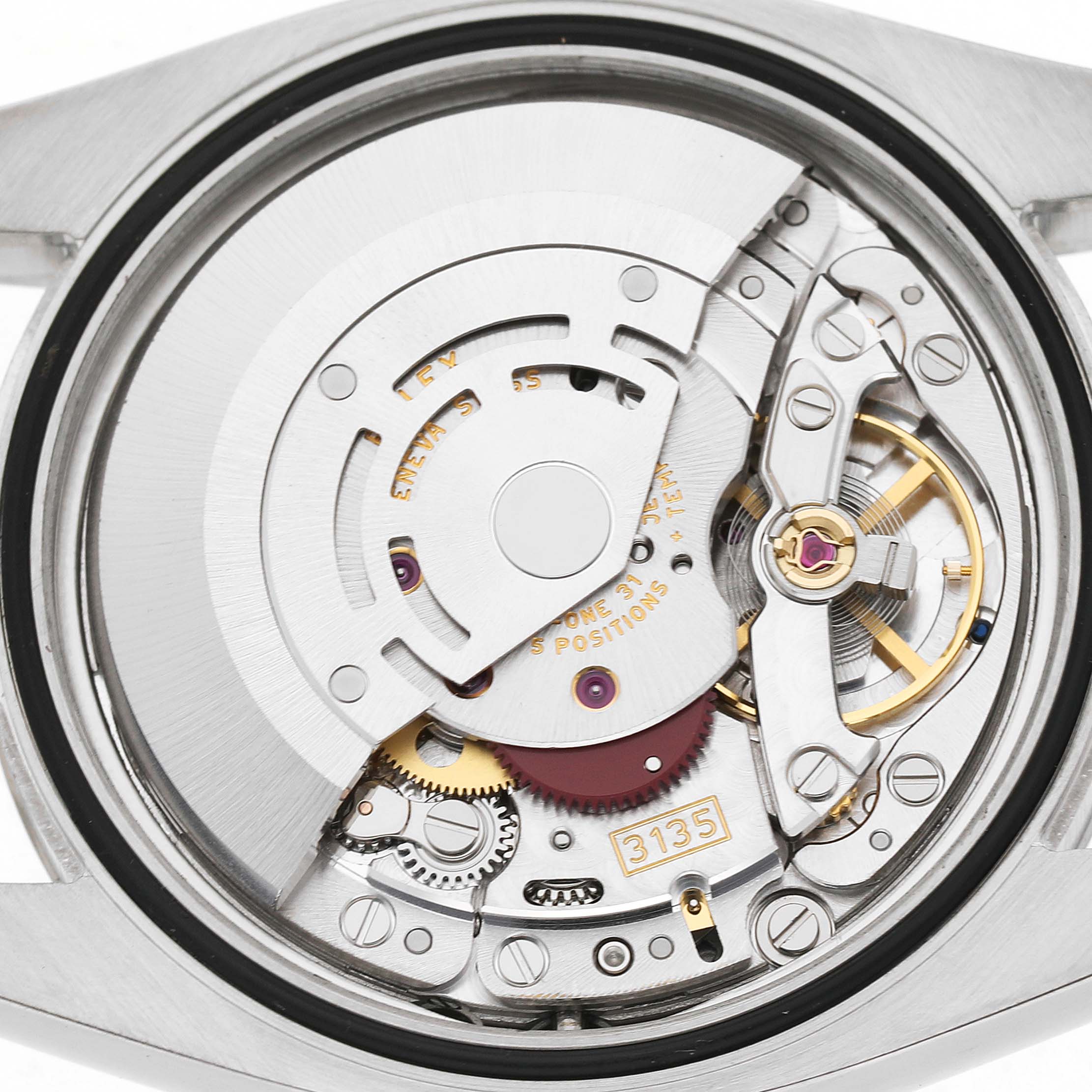 The image shows the movement of a Rolex Datejust 116234 Men's Stainless Steel Silver Dial watch from the back, highlighting its intricate mechanical parts.