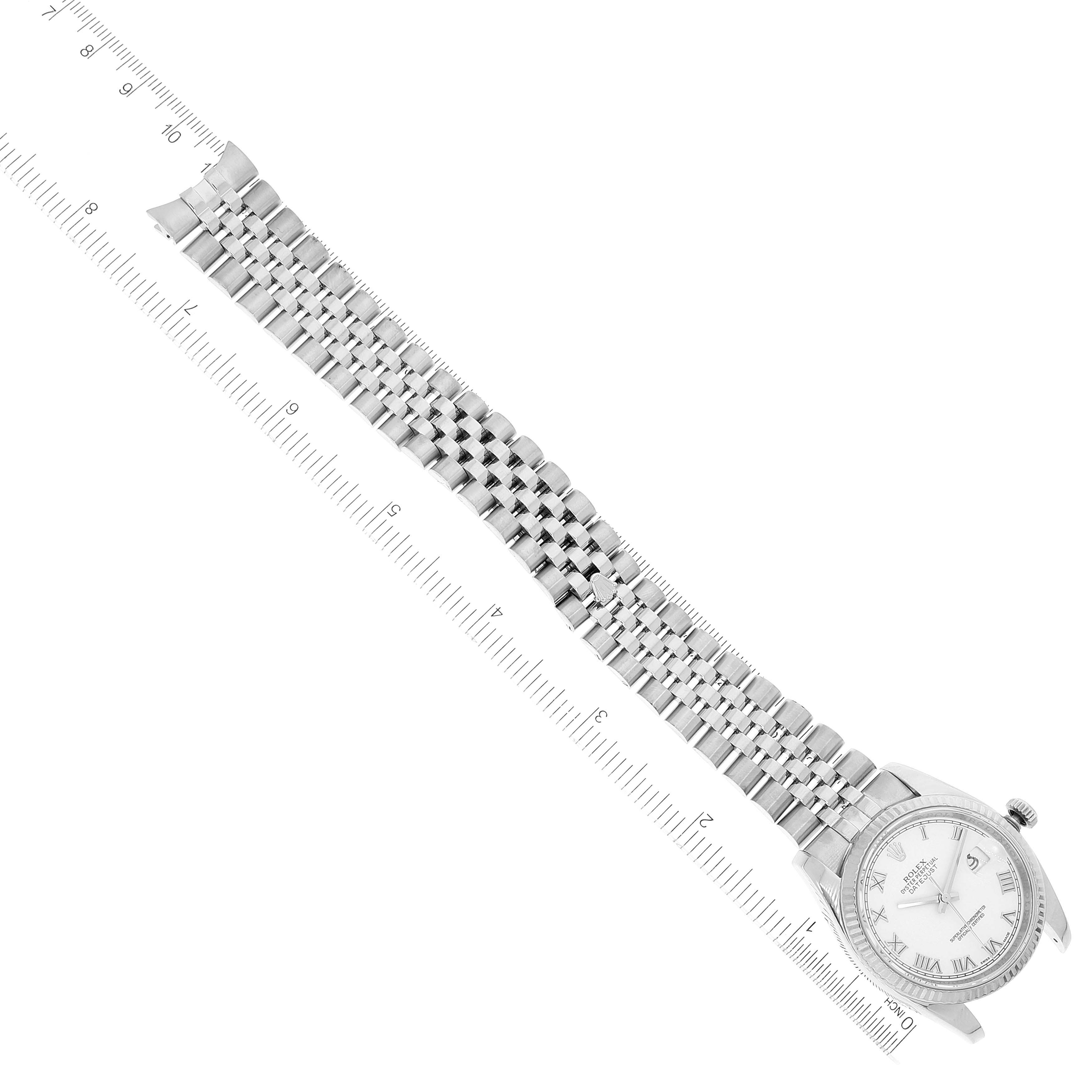 The image shows a bird's-eye view of a Rolex Datejust 116234 Men's Stainless Steel White Dial 116234 Men's Stainless Steel White Dial watch laid out flat alongside a ruler.