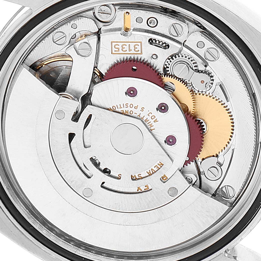 This is an interior view of the Rolex Datejust 116234 Men's Stainless Steel White Dial 116234 Men's Stainless Steel White Dial watch, showing its movement mechanism and gears.