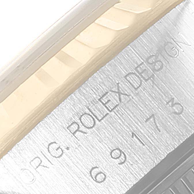 The image shows a close-up angle of the bezel and engraved case side of a Rolex Datejust 69173 Women
s Steel and Gold (two tone) Grey Dial 69173 Women
s Steel and Gold (two tone) Grey Dial watch.