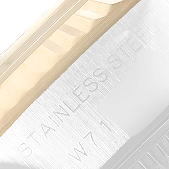 The image shows a close-up of the Rolex Datejust 69173 Women
s Steel and Gold (two tone) Grey Dial 69173 Women
s Steel and Gold (two tone) Grey Dial watch
s stainless steel case with text engraving.