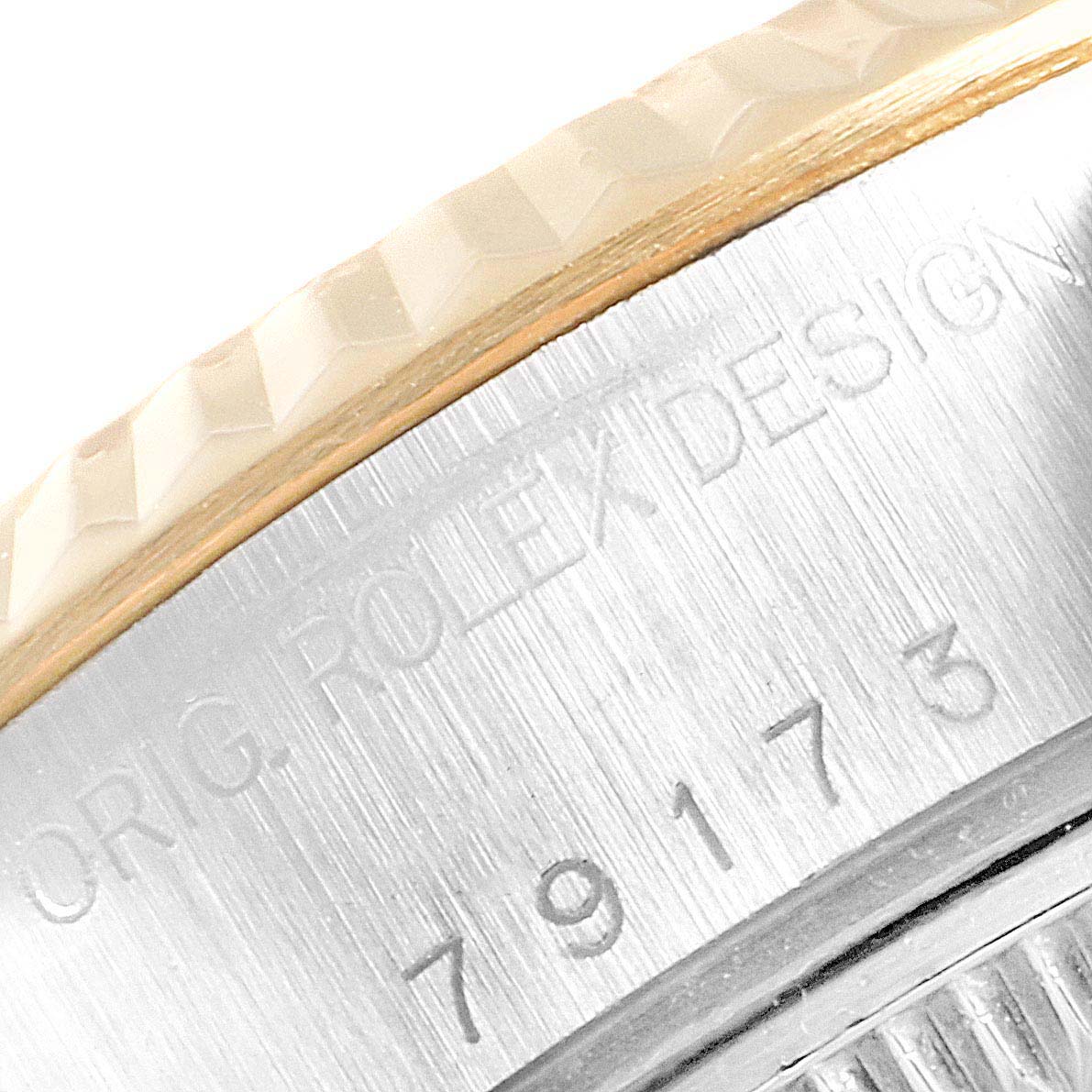 This image shows a close-up of the side of a Rolex Datejust 79173 Women
s Steel and Gold (two tone) Mother of Pearl Dial 79173 Women
s Steel and Gold (two tone) Mother of Pearl Dial watch, highlighting the fluted bezel and model number.