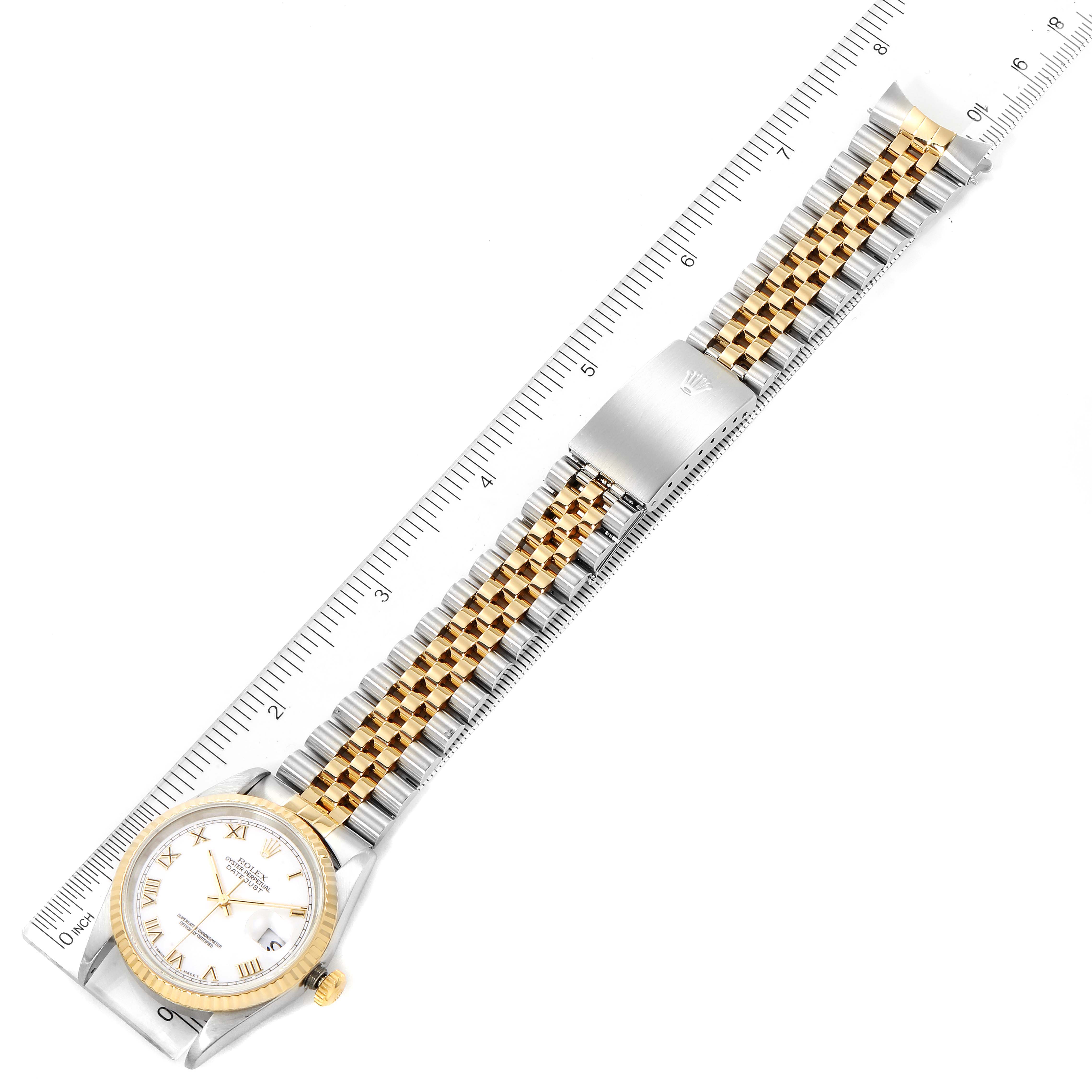 The image shows an overhead view of a Rolex Datejust 16233 Men's Steel and Gold (two tone) White Dial 16233 Men's Steel and Gold (two tone) White Dial watch with a ruler, highlighting the face, bezel, bracelet, and clasp.