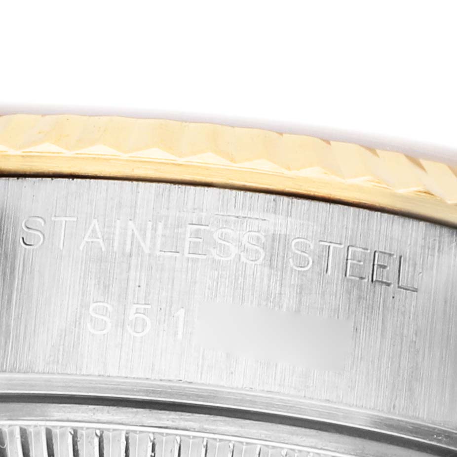 The image shows a close-up of the side of a Rolex Datejust 69173 Women's Steel and Gold (two tone) White Dial watch, highlighting the stainless steel part and engraving.