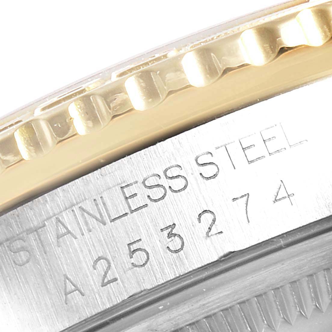 The image shows a close-up of the bezel and case edge of a Rolex Turn-o-Graph 16263 Men
s Steel and Gold (two tone) White Dial 16263 Men
s Steel and Gold (two tone) White Dial watch, highlighting the stainless steel engraving and serial number.
